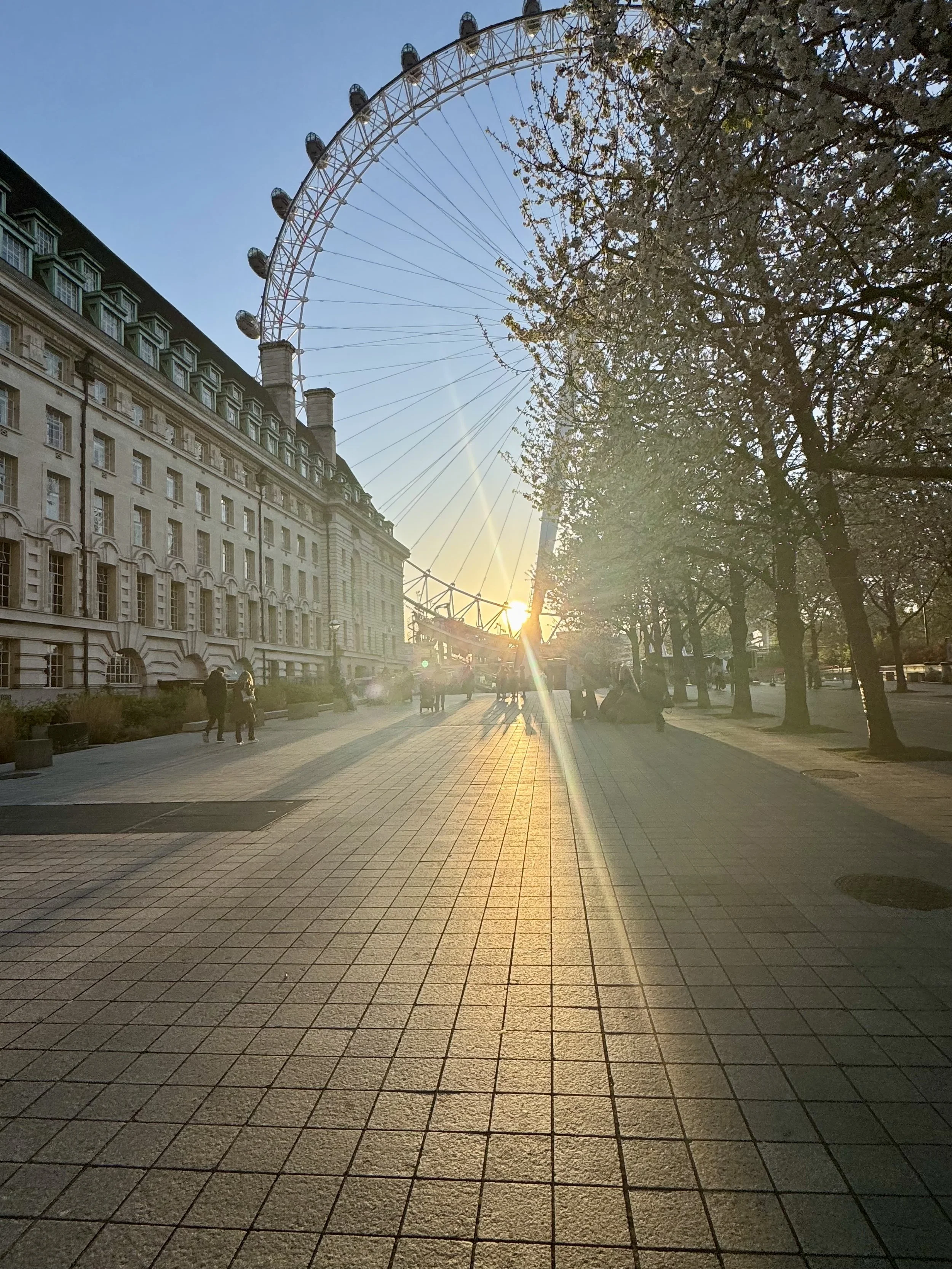 London street at sunset with the London Eye and historic architecture—classic UK city travel experience.