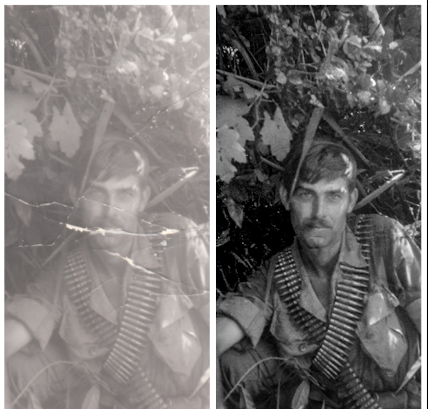 Black and white photo of a man with a mustache, in military uniform, sitting among dense foliage.