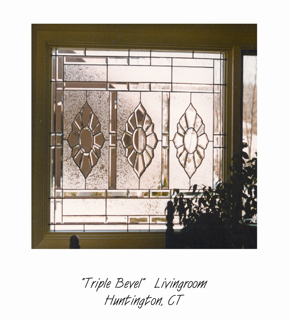Decorative stained glass window with geometric and floral patterns, sunlight filtering through, located in Huntington, Connecticut.
