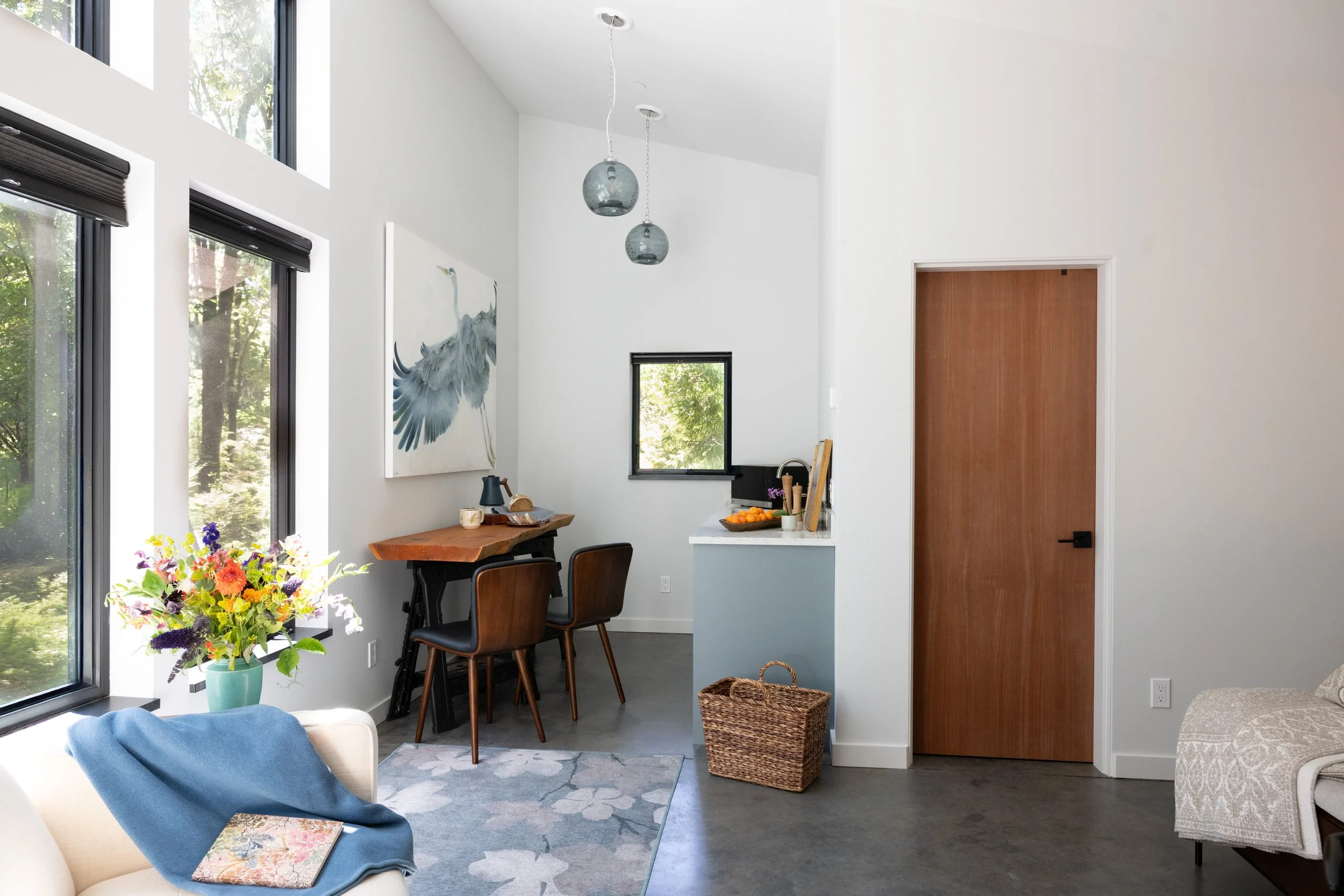 Sunny interior image of kitchenette and living space inside Maitri Guest House