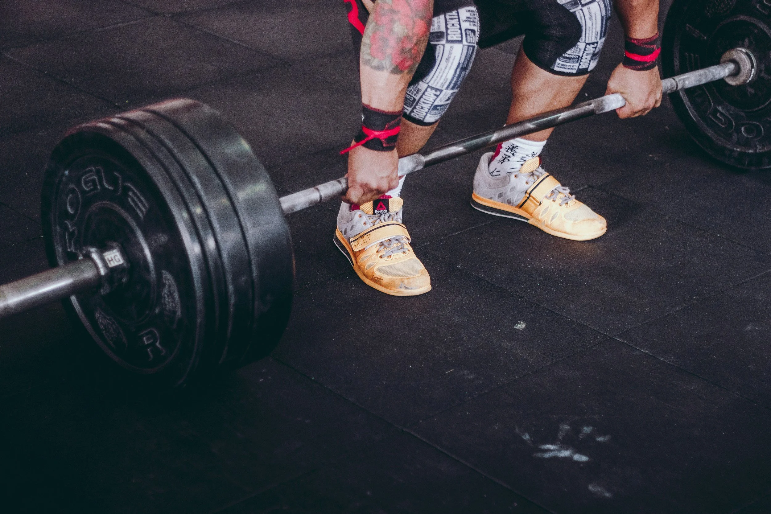 A lifter gripping a loaded barbell for a deadlift