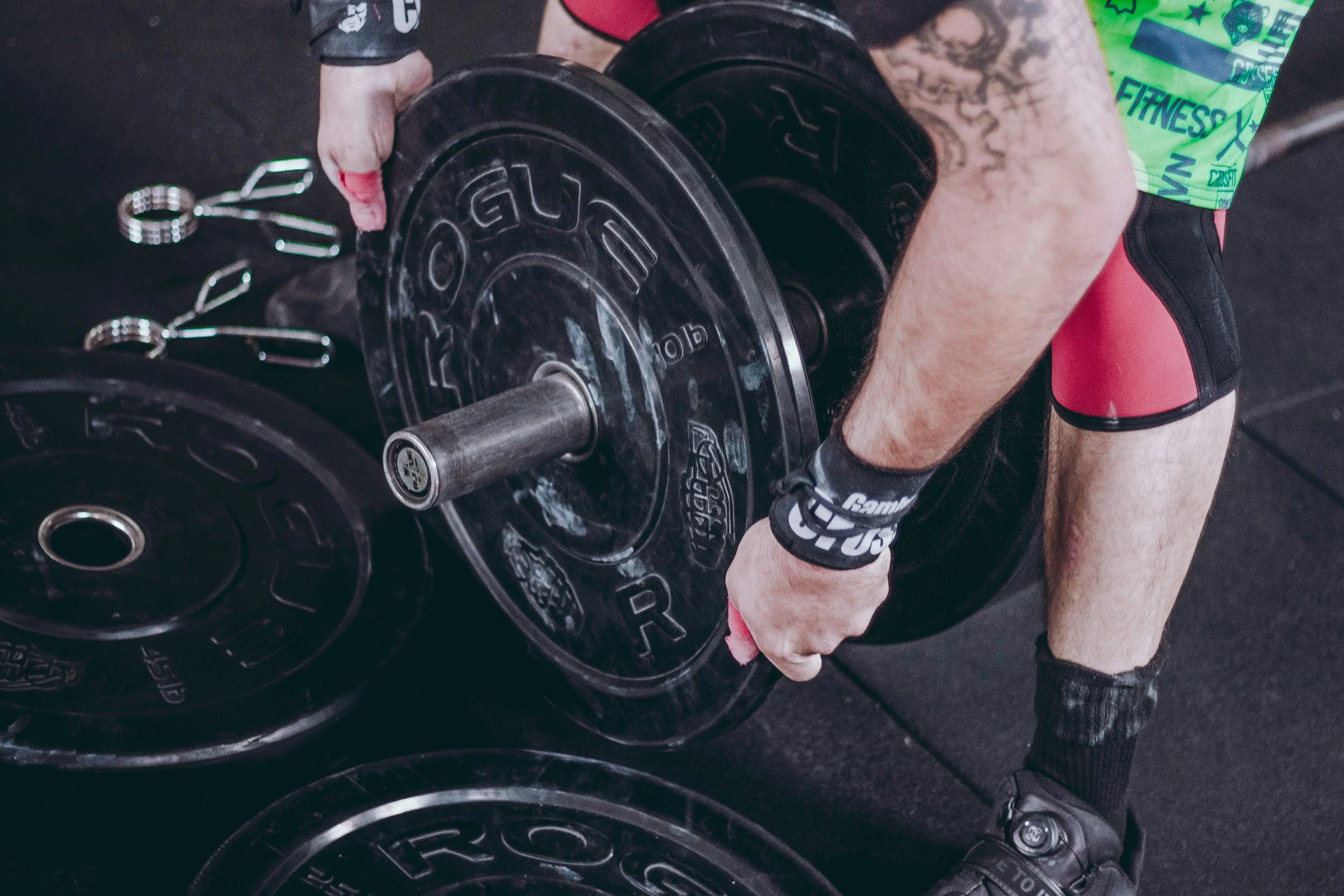 A person loading a plate onto a barbell