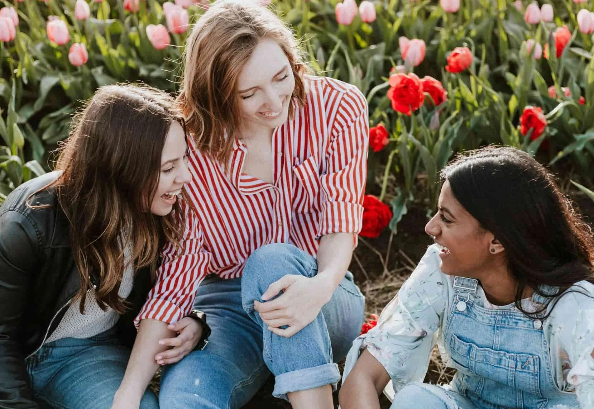 Image of teenage girls laughing in a field