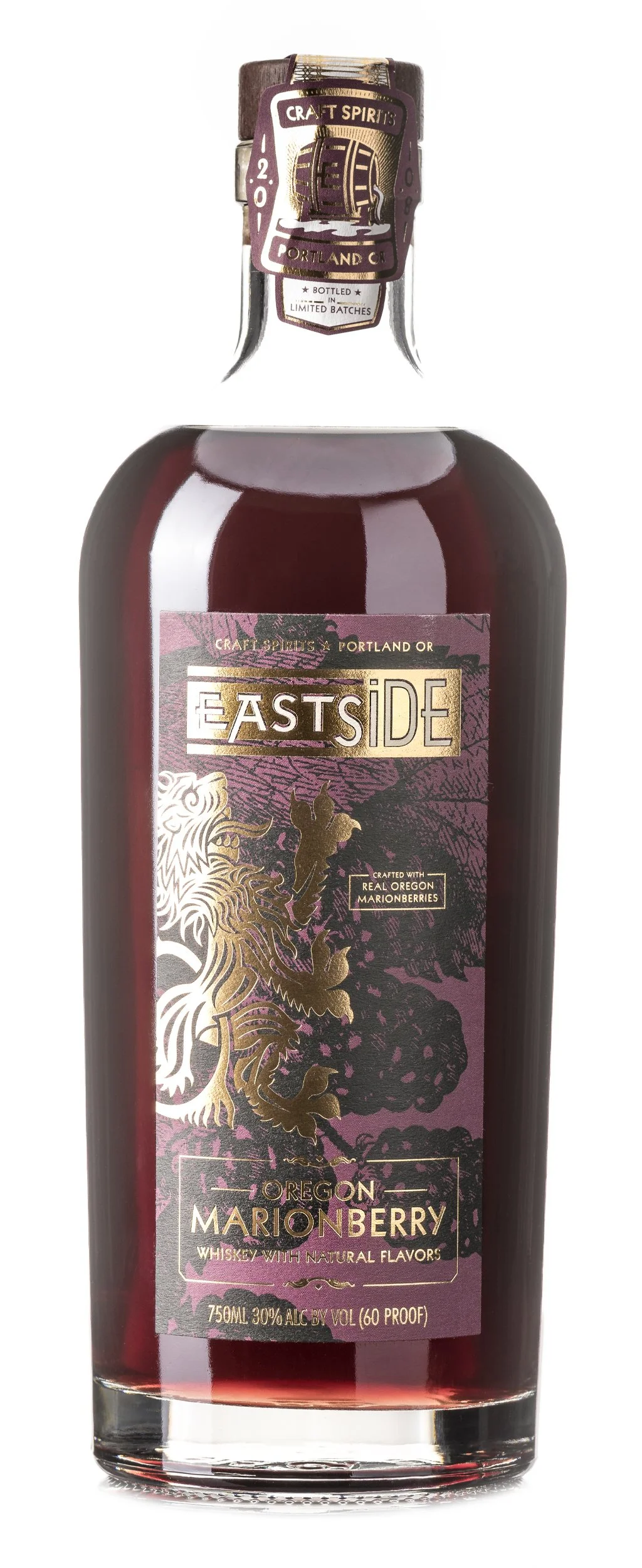 A bottle of Oregon Marionberry whiskey from Eastside Craft Spirits, featuring a purple and gold label with a lion illustration.