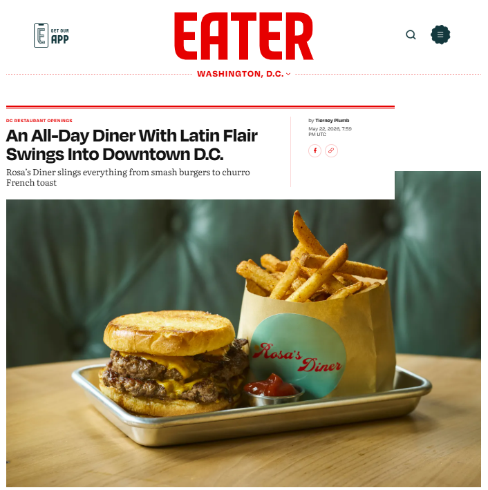 A tray with a cheeseburger and a paper bag of French fries at Rosa's Diner