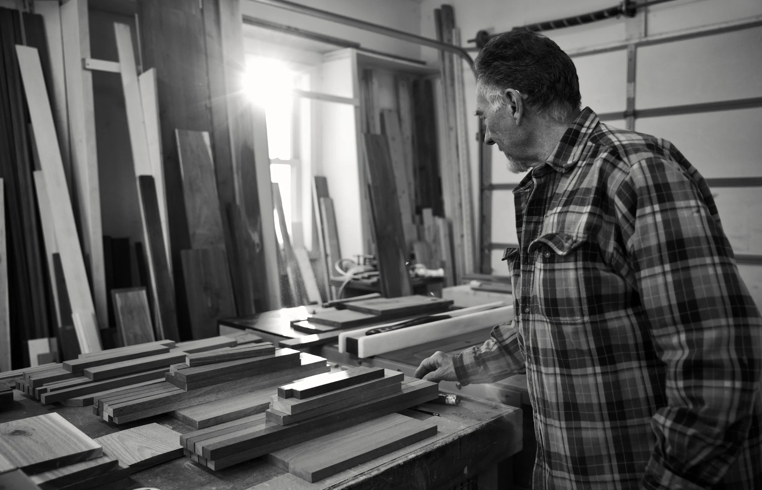 R.E. Arnold's Custom Construction — Bob at his workbench surrounded by hardwood lumber in Gettysburg, PA