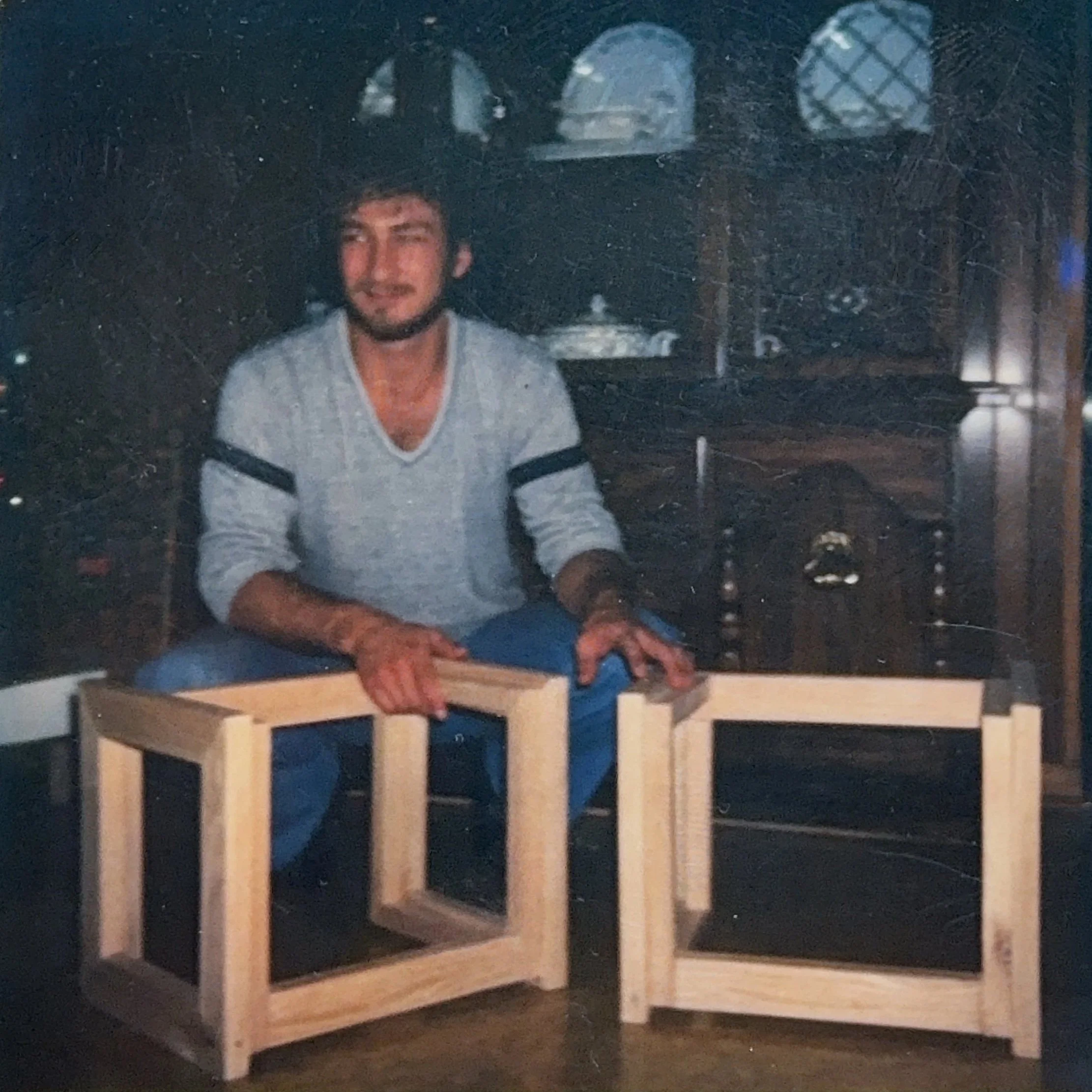R.E. Arnold's Custom Construction — young Bob with handmade wooden chairs early in his carpentry career