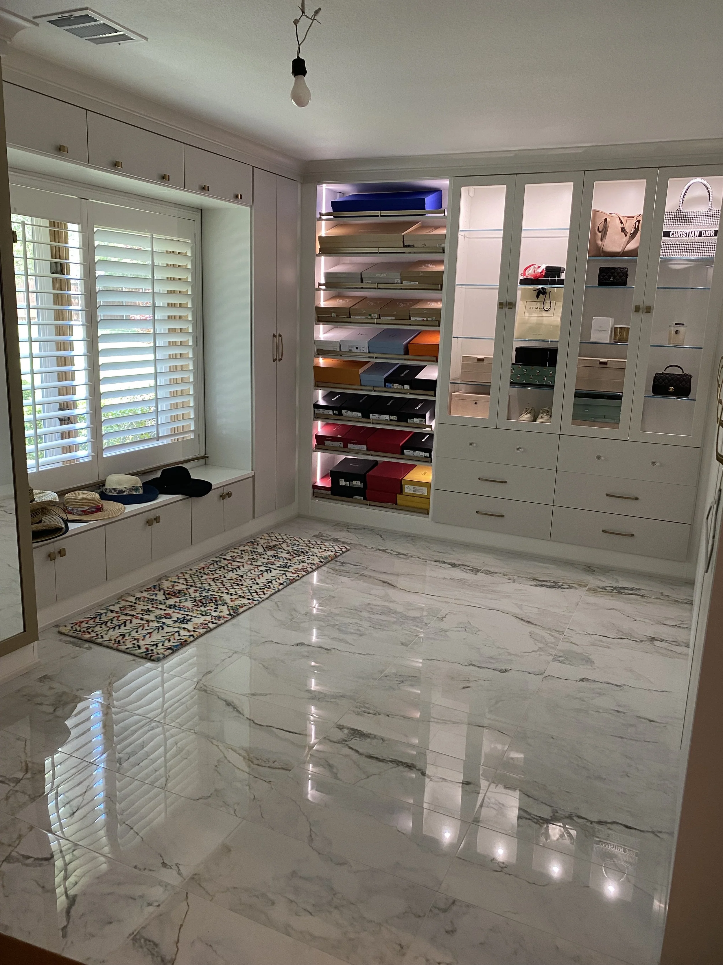 Marble-Look Porcelain Closet Floor – Sachse, TX. 12" × 24" Gala Bronzed Lace marble-look porcelain tile creates a clean, elegant surface that enhances this custom walk-in closet.