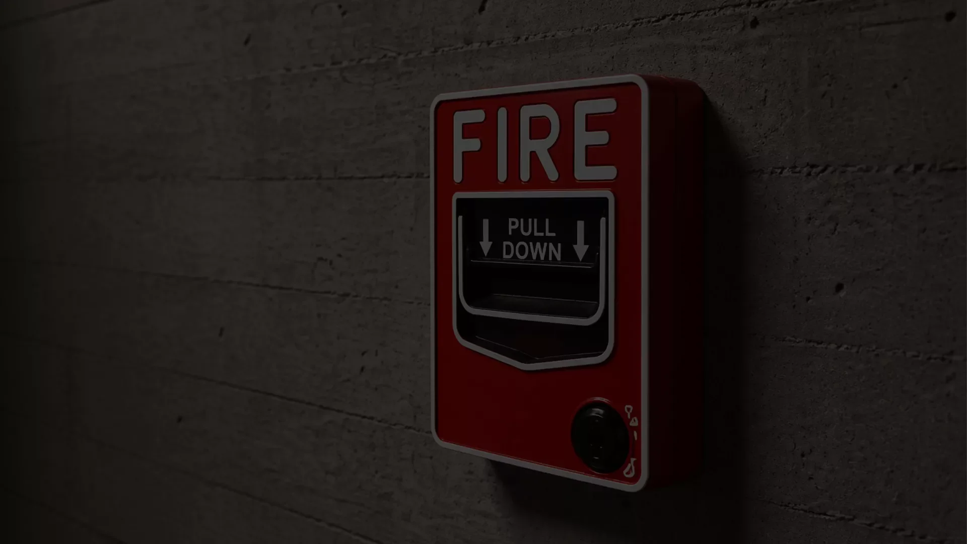 A red fire alarm pull station mounted on a red textured wall.
