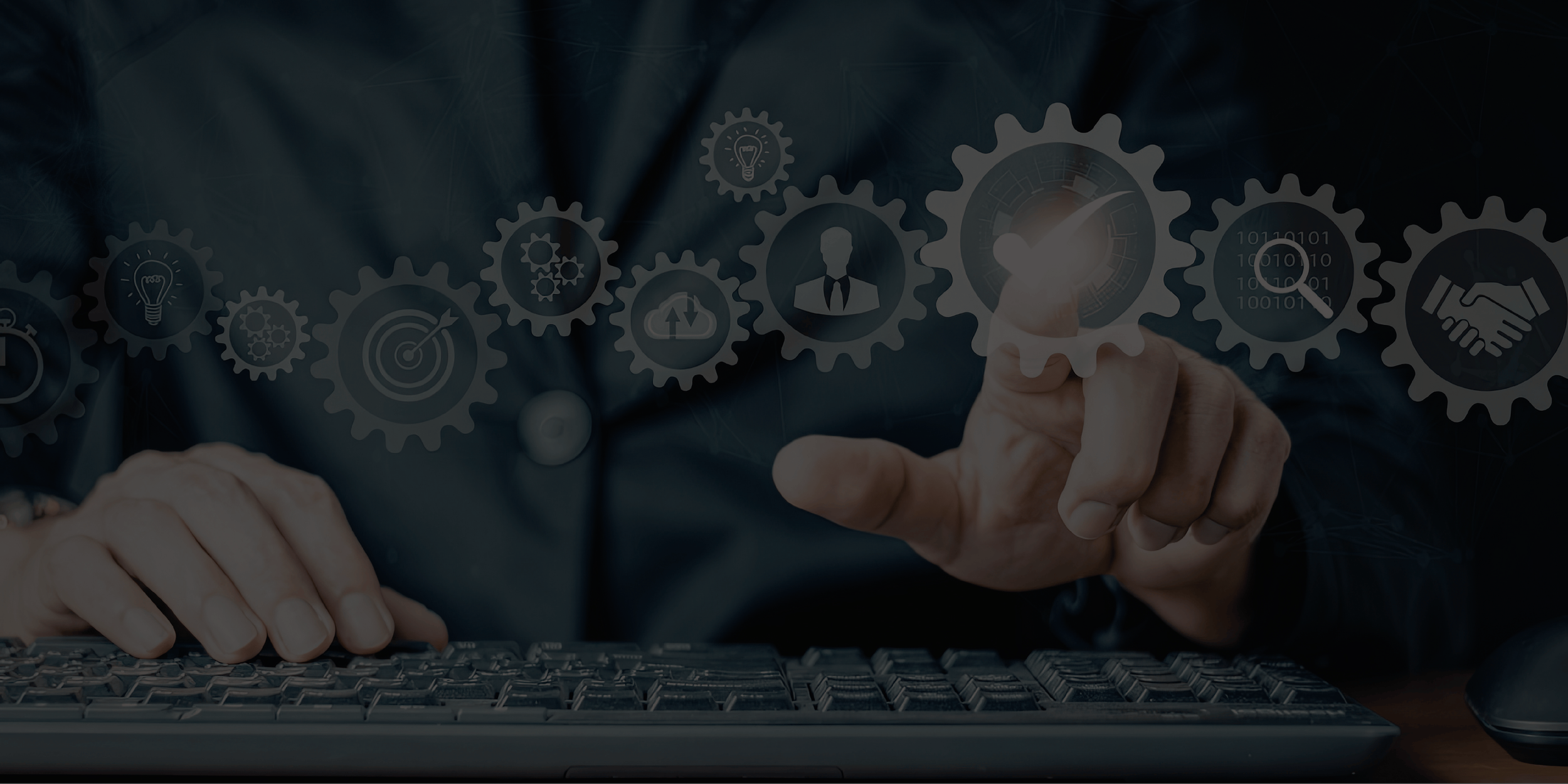 A person using a computer keyboard with a transparent digital interface showing interconnected gears and icons related to innovation, management, and technology.