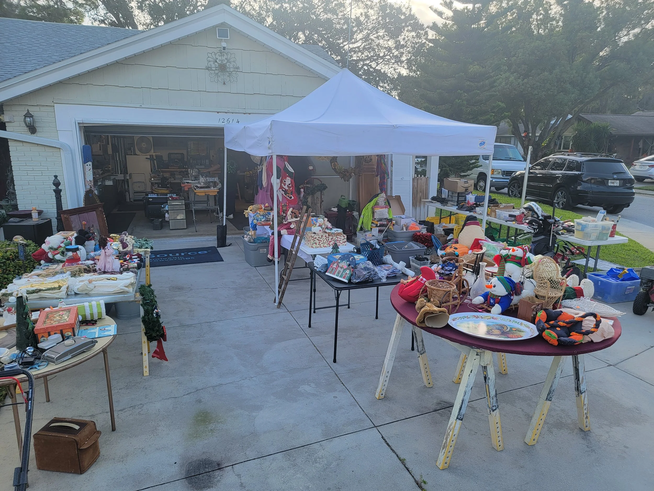 Estate sale setup with organized tables of household items arranged for clear browsing and sale flow.
