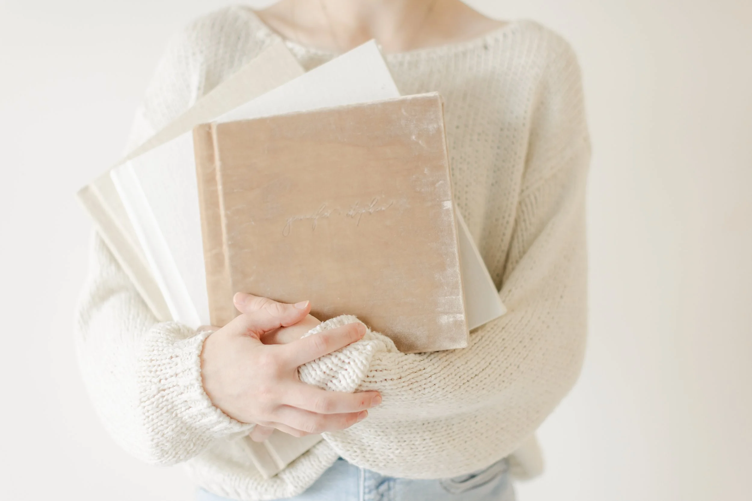 Sarah eddlemon photography heirloom family portraits - image of woman holding heirloom photo albums