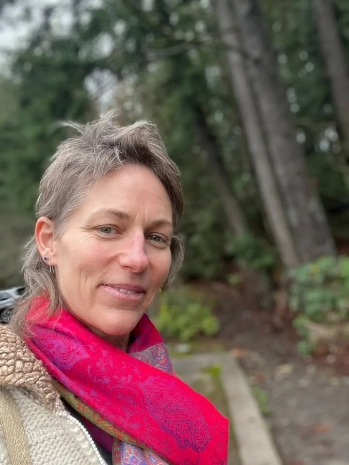 Selfie of OHTP student Melissa in the forest wearing a bright pink scarf