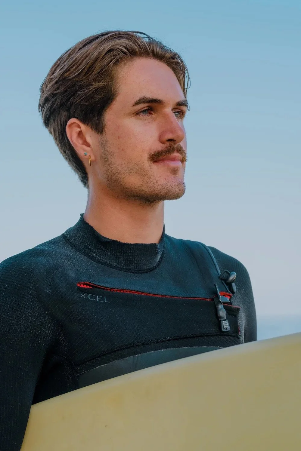 Headshot of surf therapist Nathaniel Mills gazing to the side