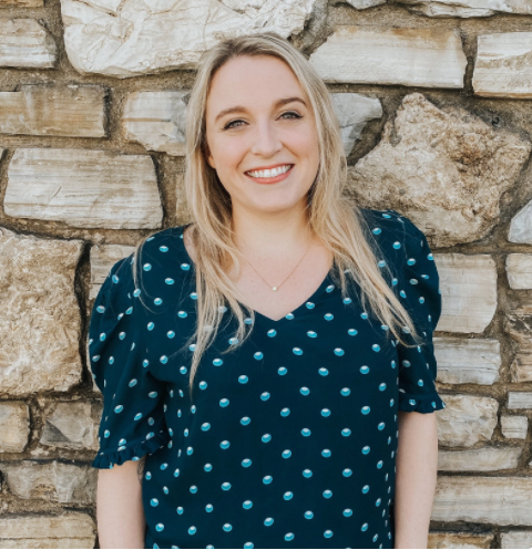 Headshot of OHTP student Daneeka standing against a stone wall