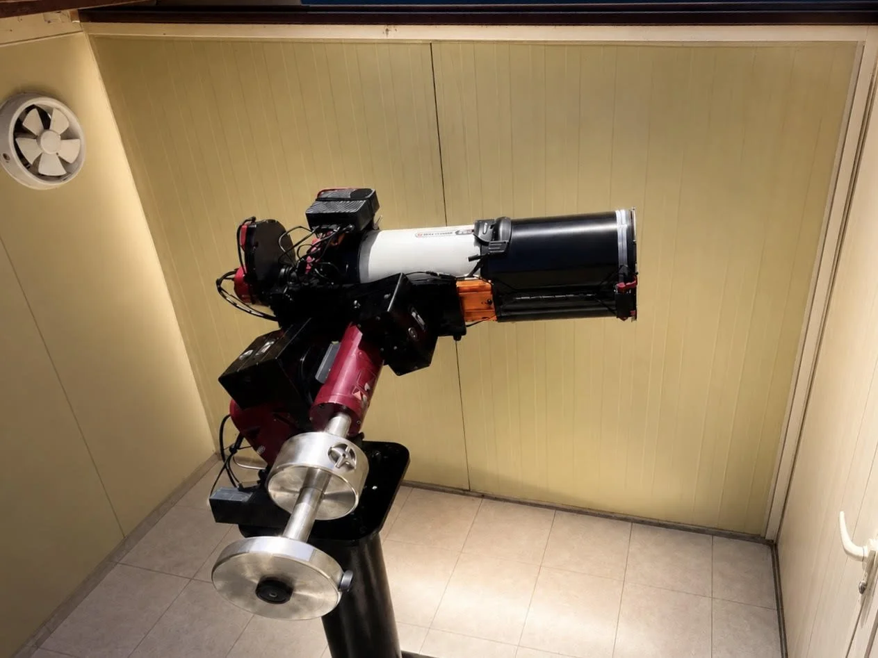 A telescope with various components mounted on a pier inside a room with beige walls and tile flooring at Eden Emirates Observatory in Razeen Desert, Abu Dhabi, UAE