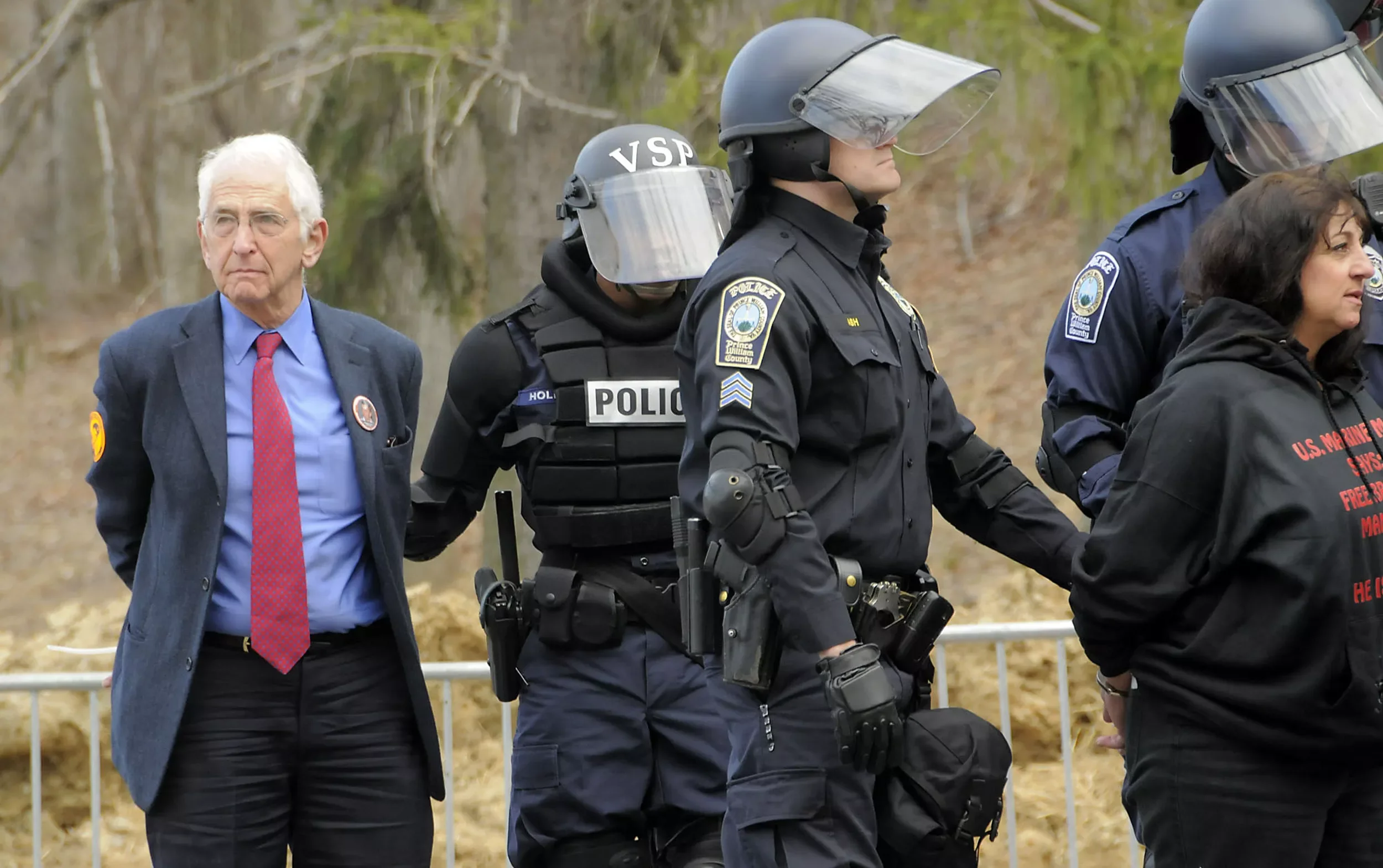 Daniel Ellsberg arrested by police officers at a protest