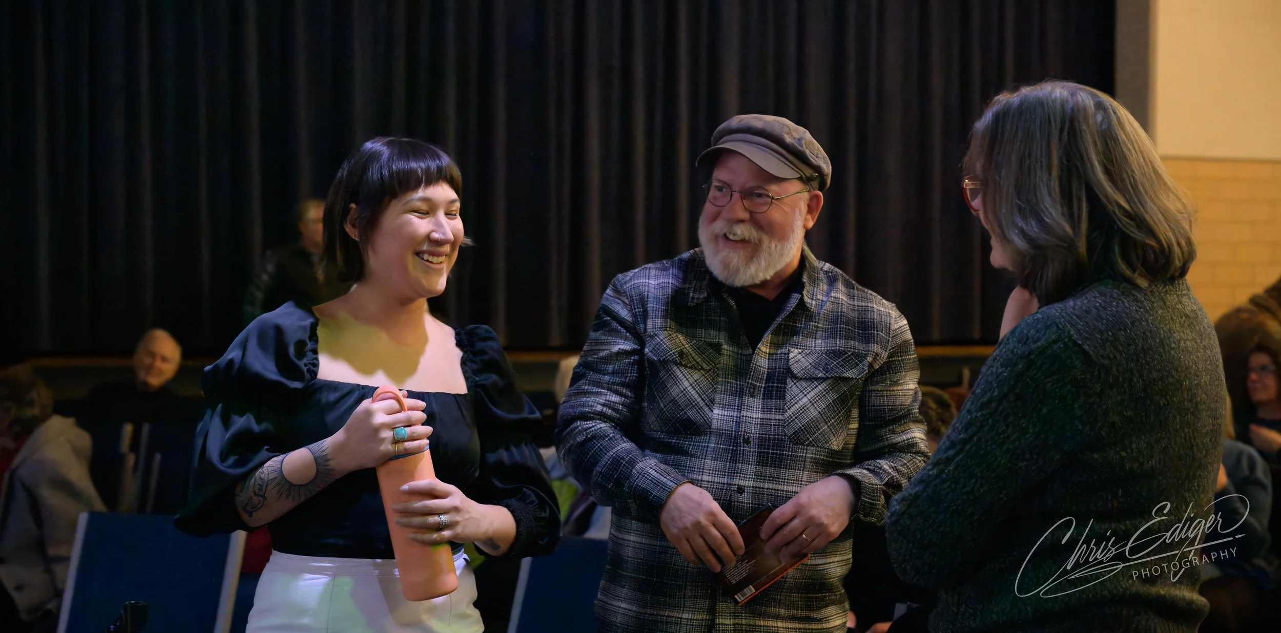 Rachel Lovelace of The Swallowtails chatting with audience members during a break during their performance at Green Guitar.