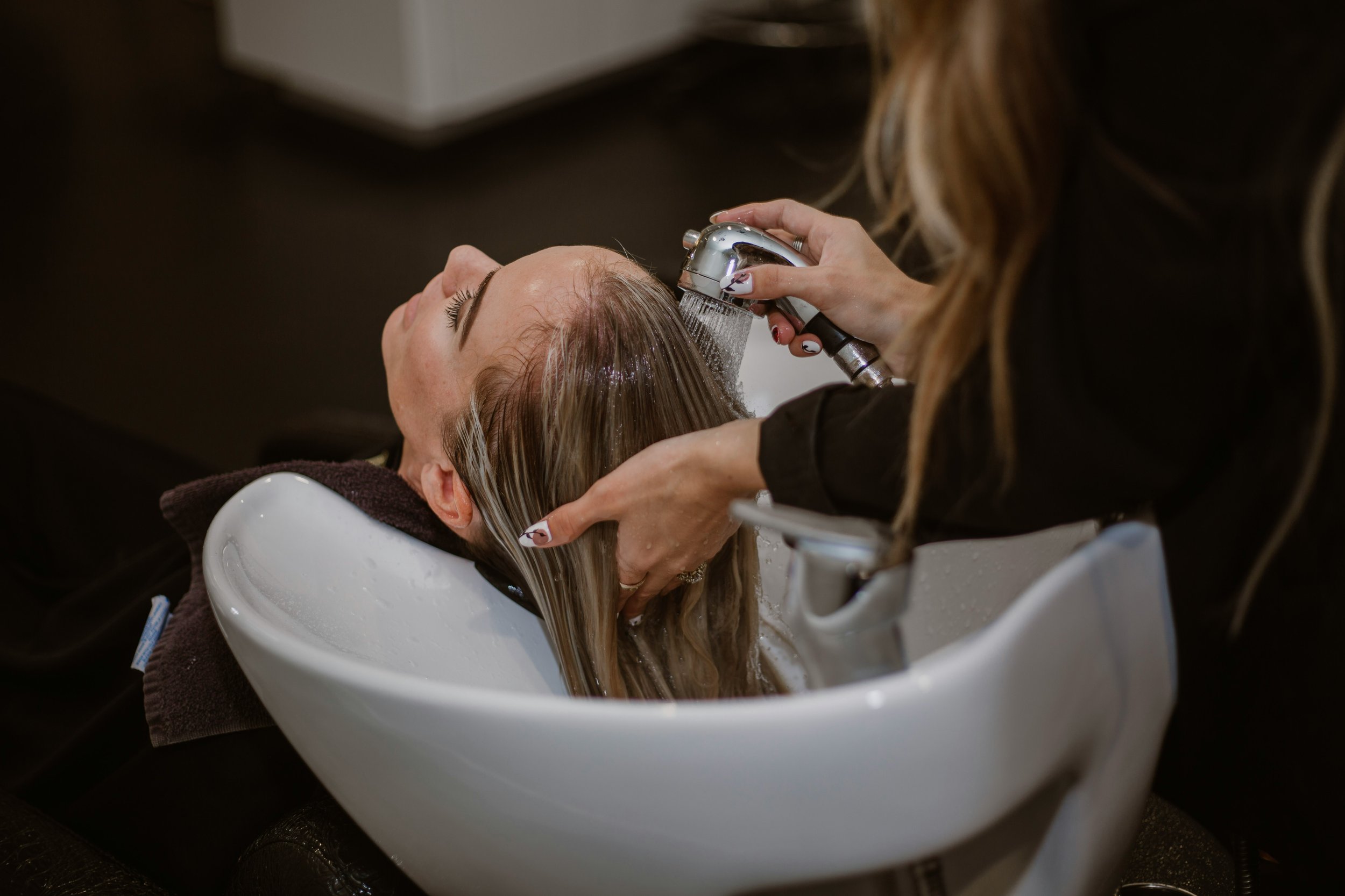 Woman experiencing the relaxing Reset Ritual at luxury salon in Frisco, TX.