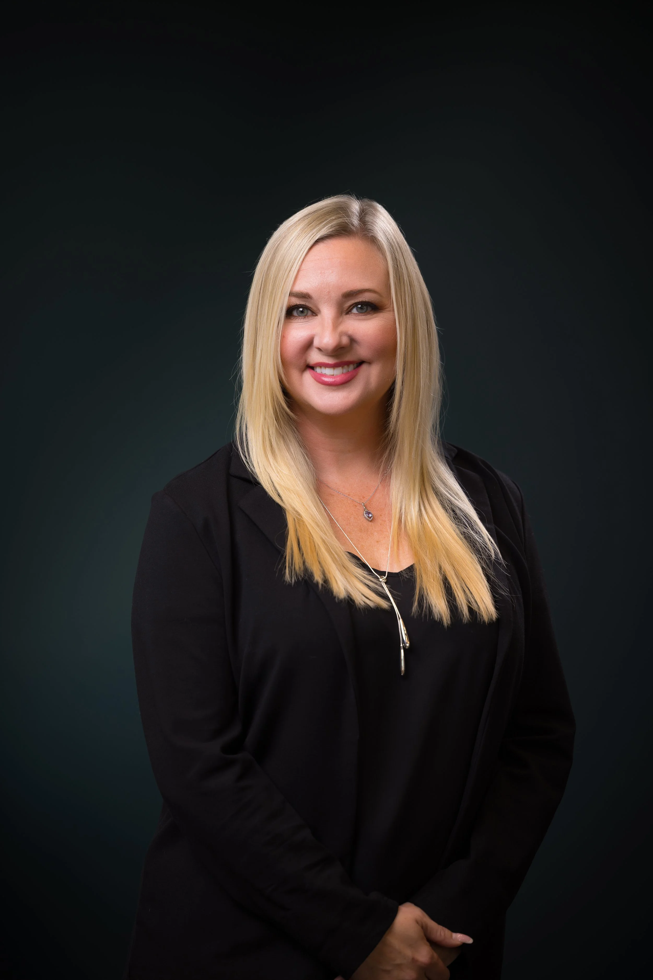 Ashley, a stylist in Frisco, TX, specializes in blonding, gray coverage, corrective color, balayage, dimensional color, rich red tones, and bold fashion shades.