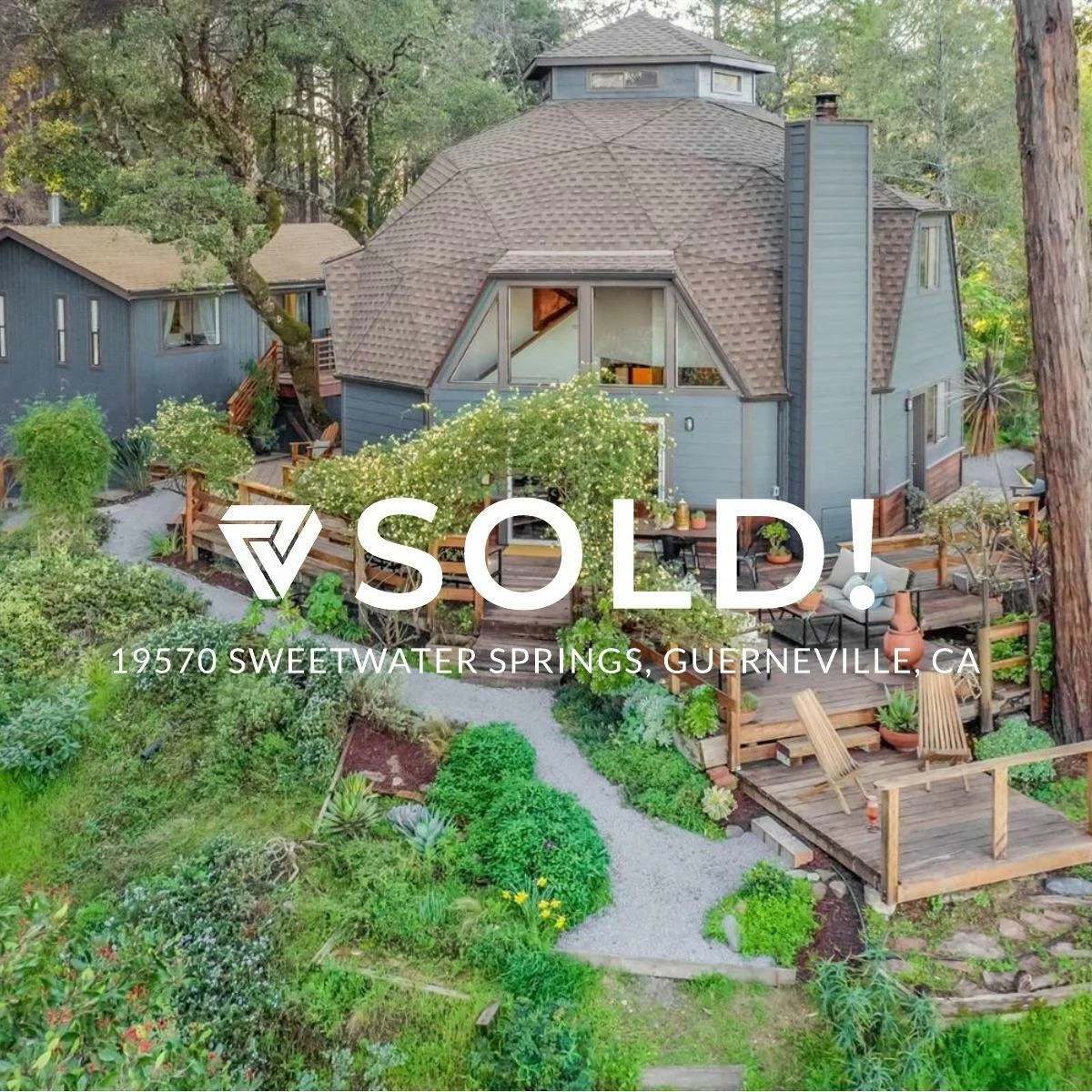A house with a unique geodesic dome design surrounded by lush greenery and outdoor patio furniture, located at 19570 Sweetwater Springs, Guerneville, California. The house has a deck and garden area, with trees and plants around it.