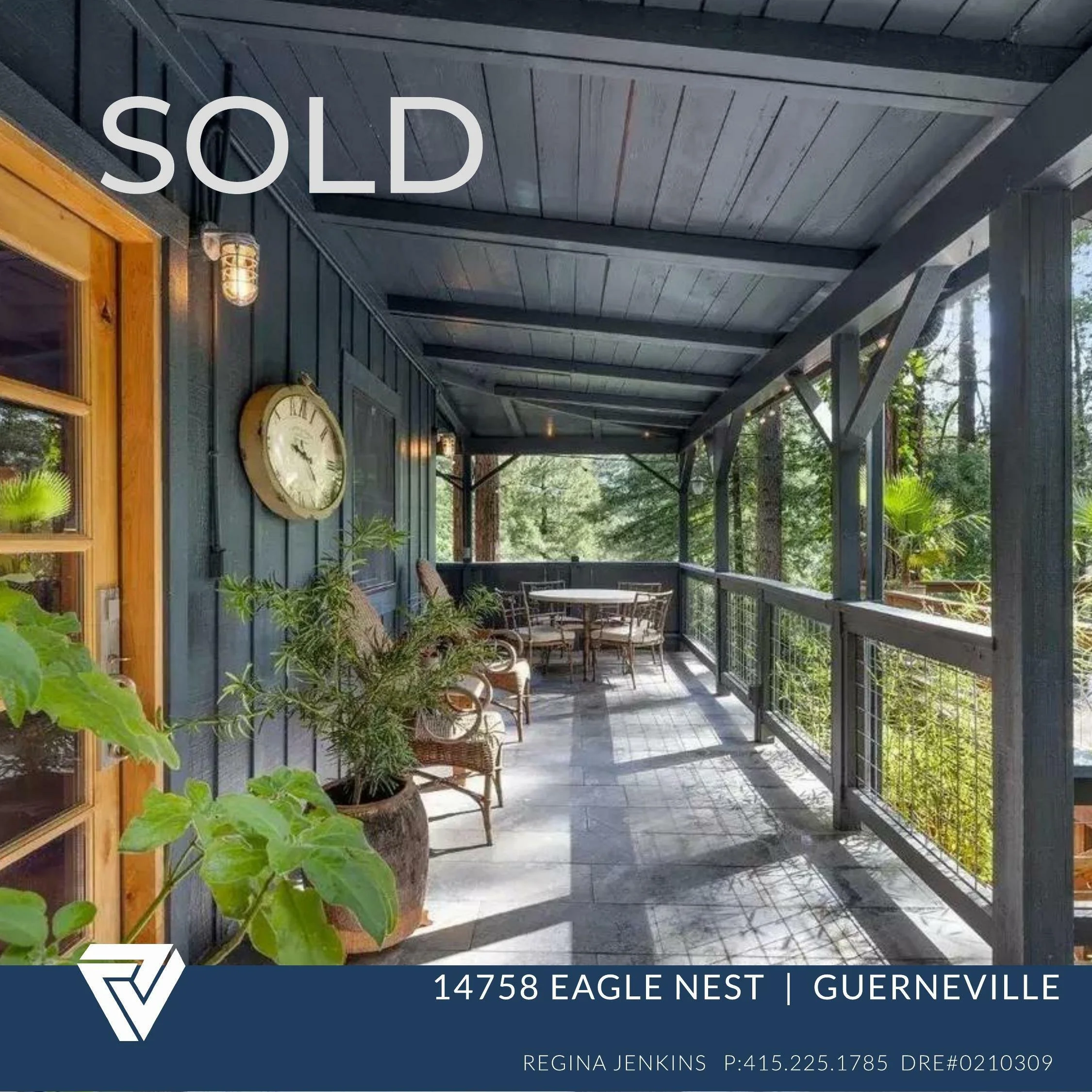 Covered outdoor balcony with potted plants, chairs, and table, featuring a wall clock and 