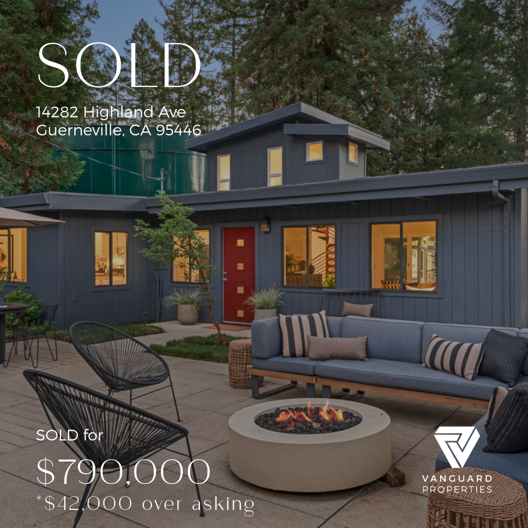 A modern house with a blue exterior, multiple windows, a red door, outdoor patio furniture, and a fire pit, with sold overlay and property details.