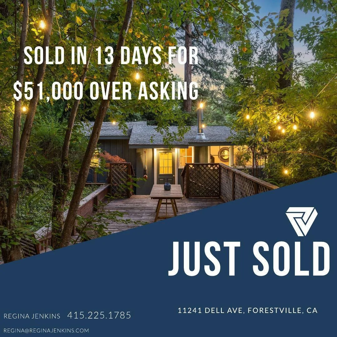 A house in a wooded area decorated with string lights, with a porch and outdoor furniture.