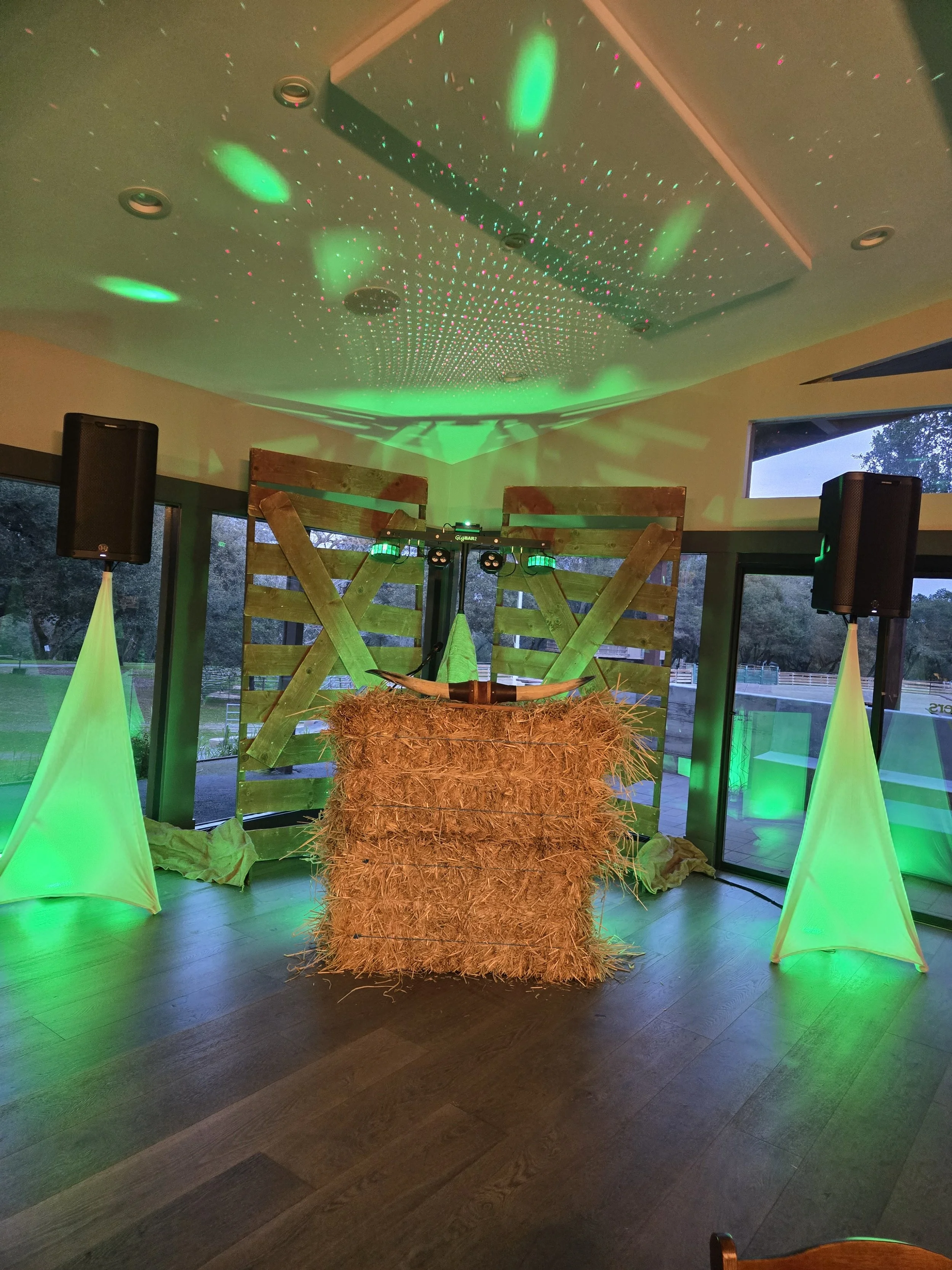 Rustic country-themed event setup by DJ Shivers featuring hay bale decor, wooden backdrop, and lighting for a Bay Area line dancing and country DJ private event.