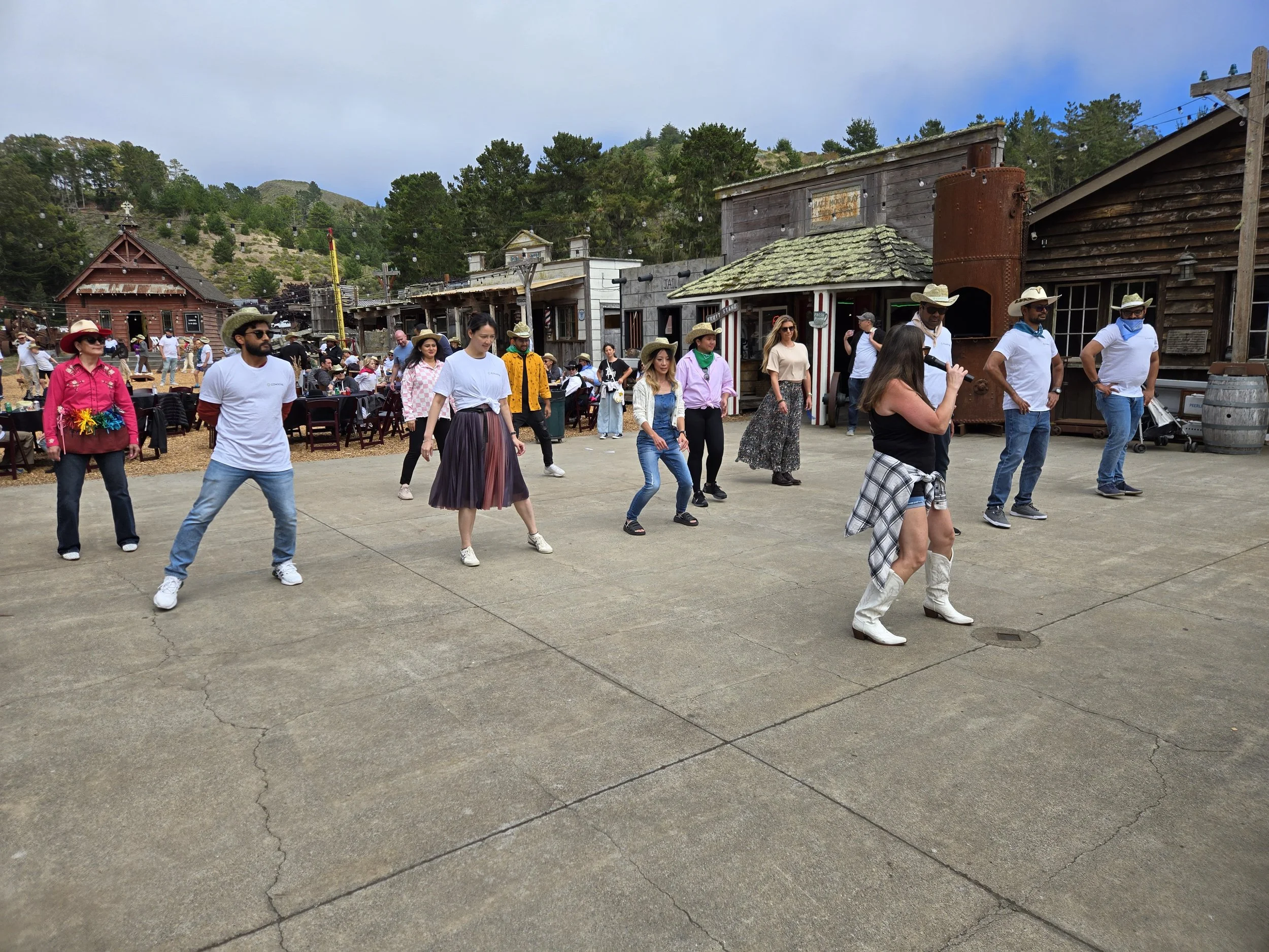 DJ Shivers and Line Dancing Lisa instructing dancers how to Line dance at a private corporate offsite event in Half Moon Bay.