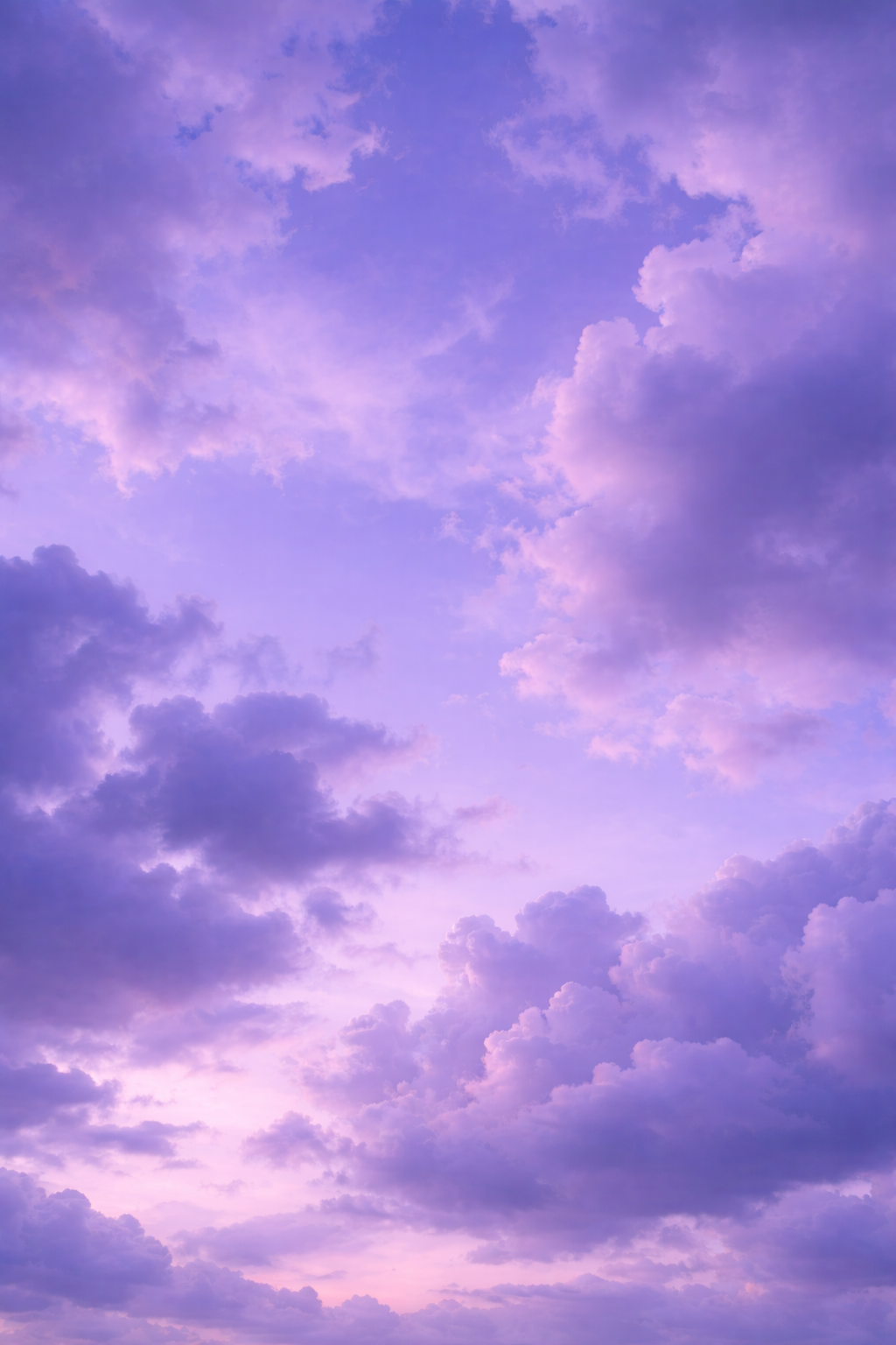 A sky with purple and pink clouds during sunset or dawn.