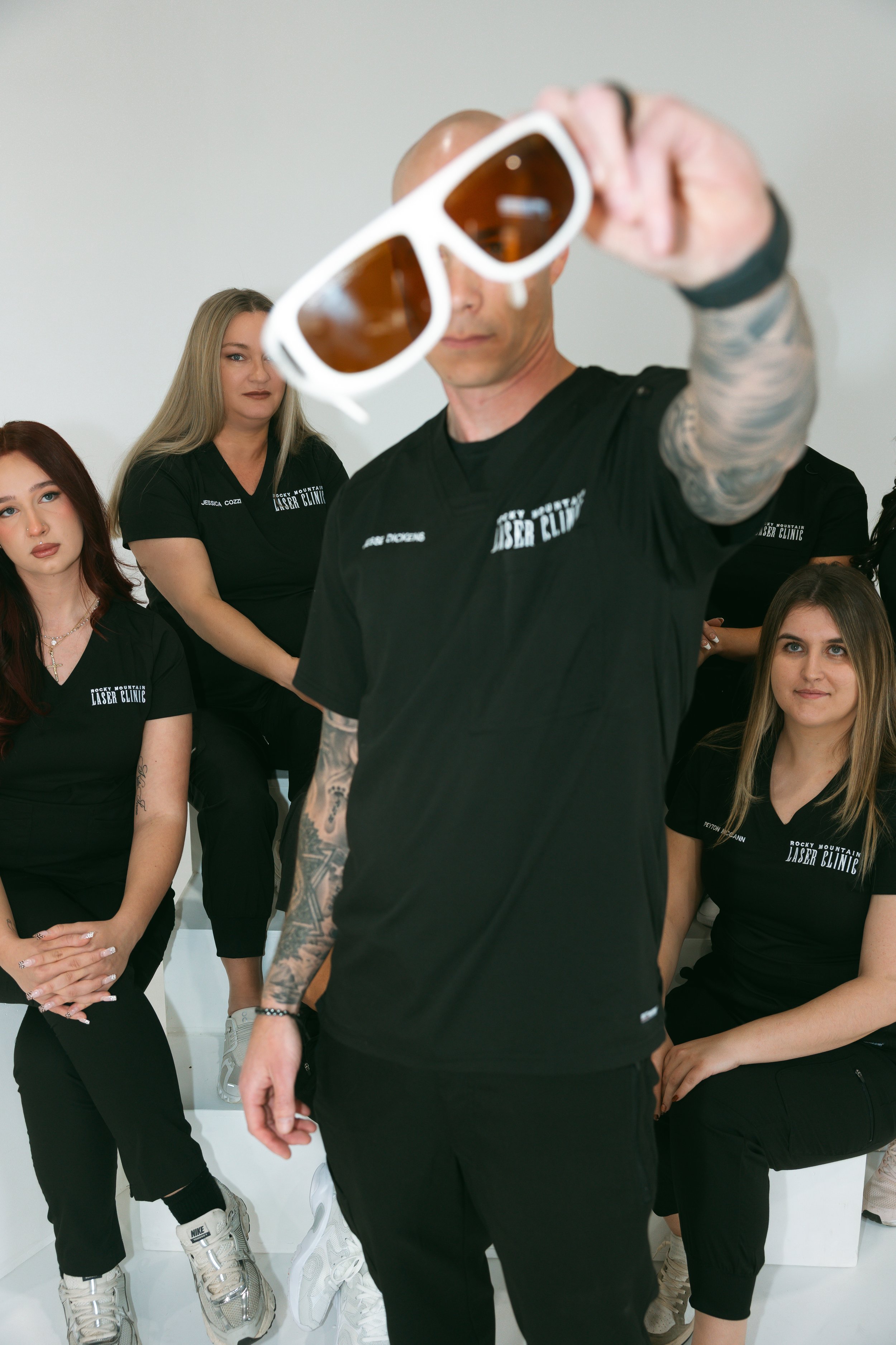 Group of young adults in black t-shirts with