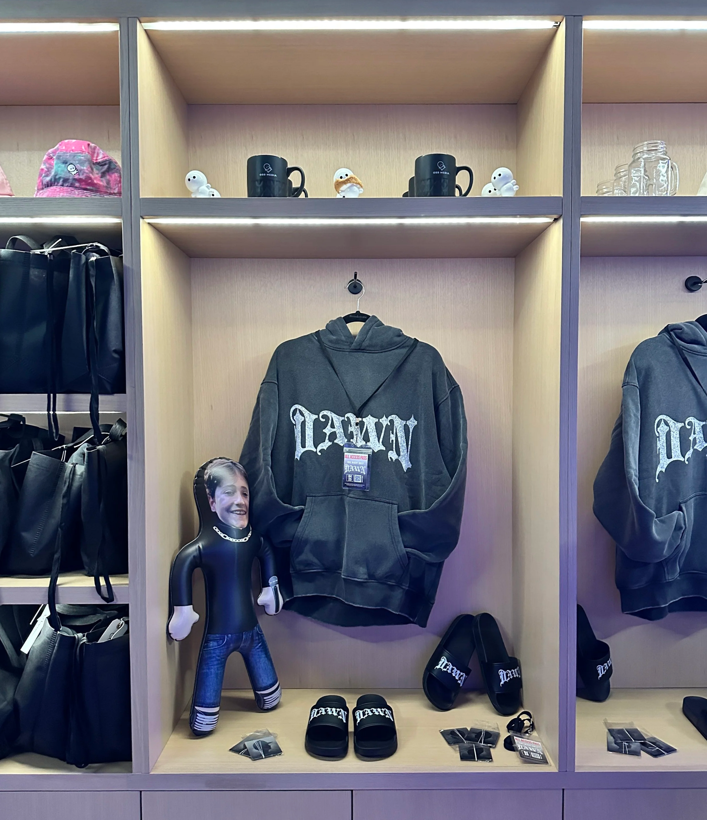 A merch display featuring a custom bar mitzvah logo on a hoodie as a party gift