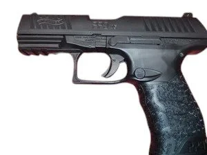 Black semi-automatic handgun with textured grip, viewed from the side.