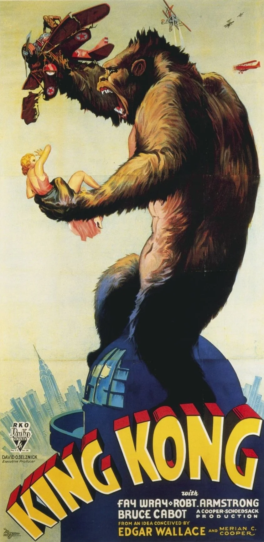 A giant ape holding a woman in its hand, with vintage airplanes flying in the sky above, and the New York City skyline in the background. The poster is for the movie 'King Kong'.