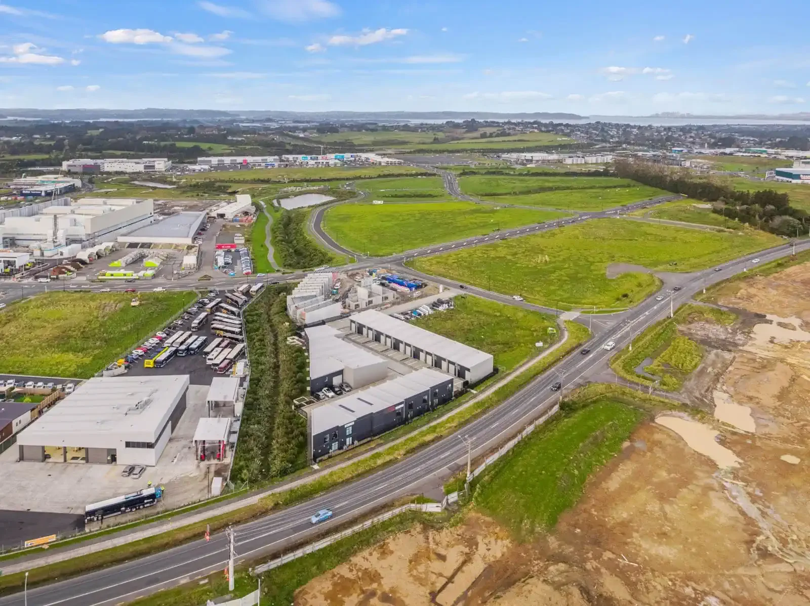 Aerial drone view of a modern industrial property in Auckland. The expansive property highlights excellent real estate opportunities with direct access to major roads and infrastructure.
