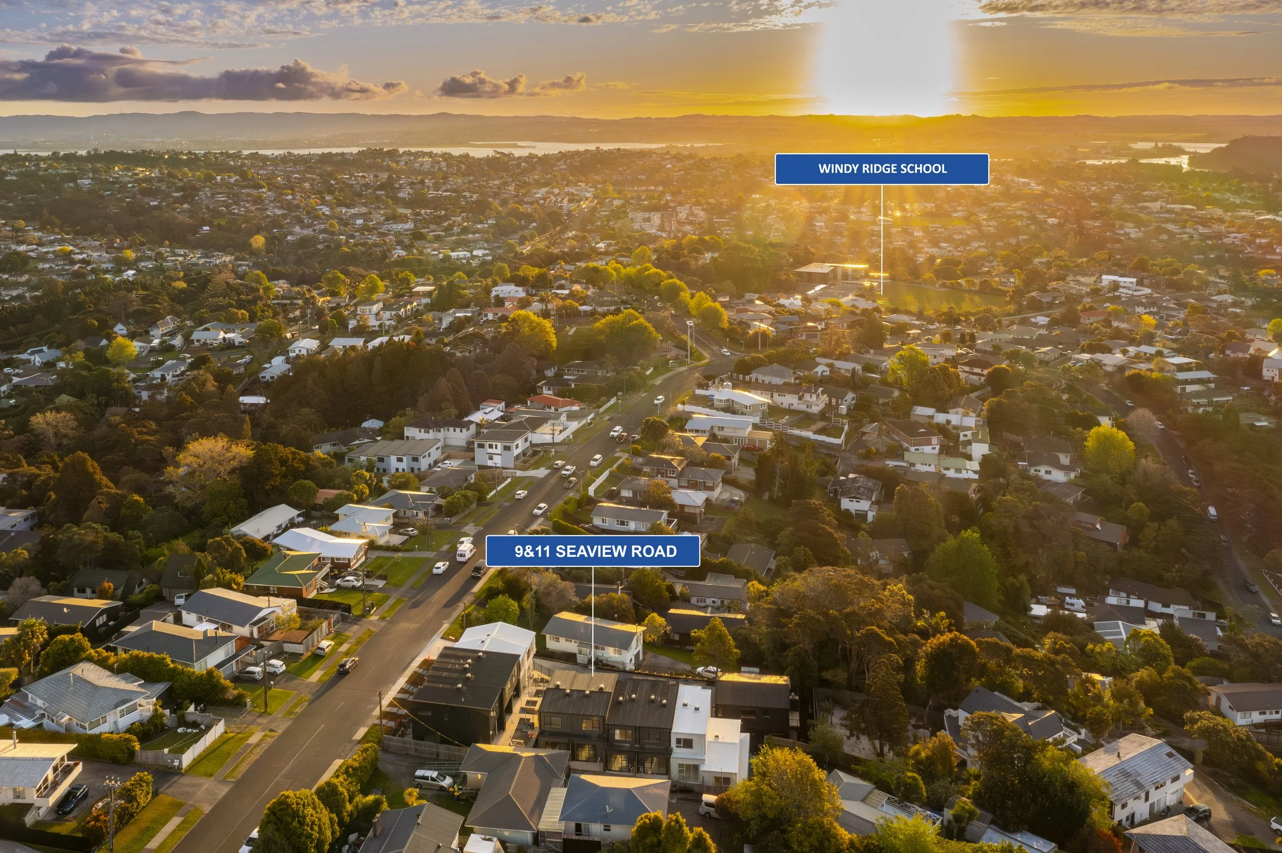 An aerial sunset view of a leafy residential neighborhood highlighting the 9 and 11 Seaview Road property and its proximity to Windy Ridge School.