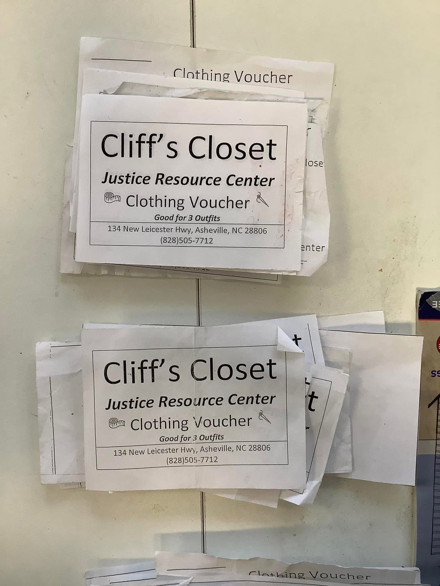 Two stacks of clothing vouchers from Cliff's Closet Justice Resource Center, each good for three outfits, located at 134 New Leicester Hwy, Asheville, NC, with phone number 828-505-7712, pinned on a white surface.