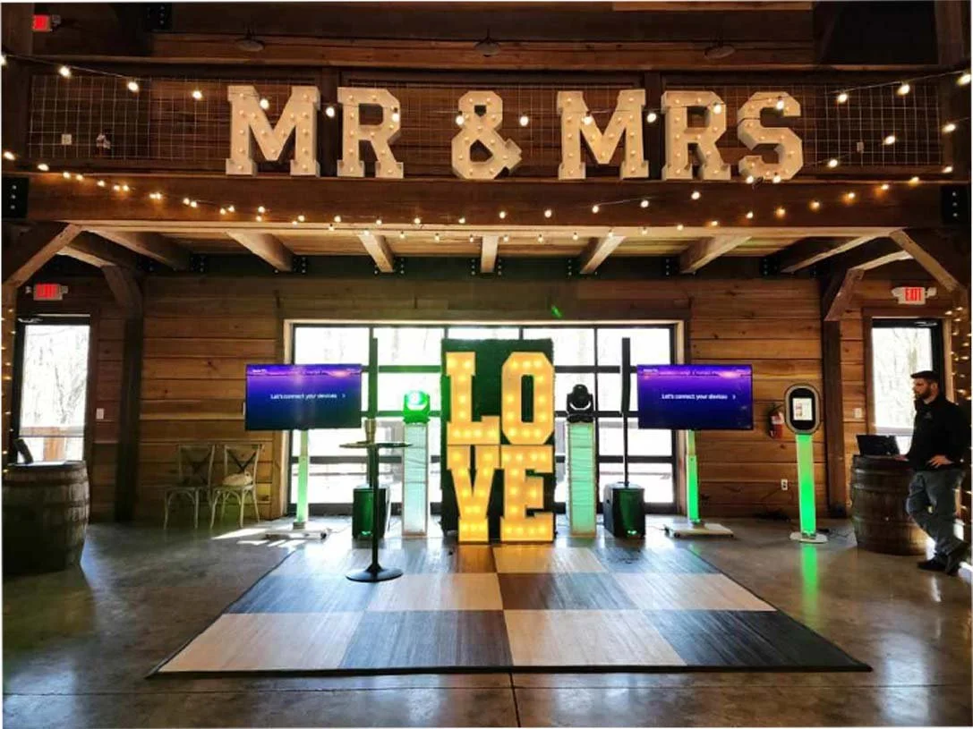 Wedding reception inside marquee tent with dance floor and lighting