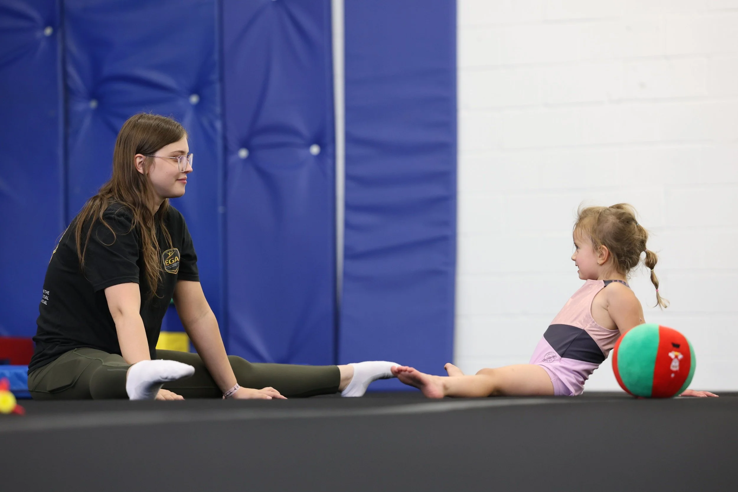 EGA gymnastics coach working with a young gymnast at Elite Gymnastics Academy in Oakville