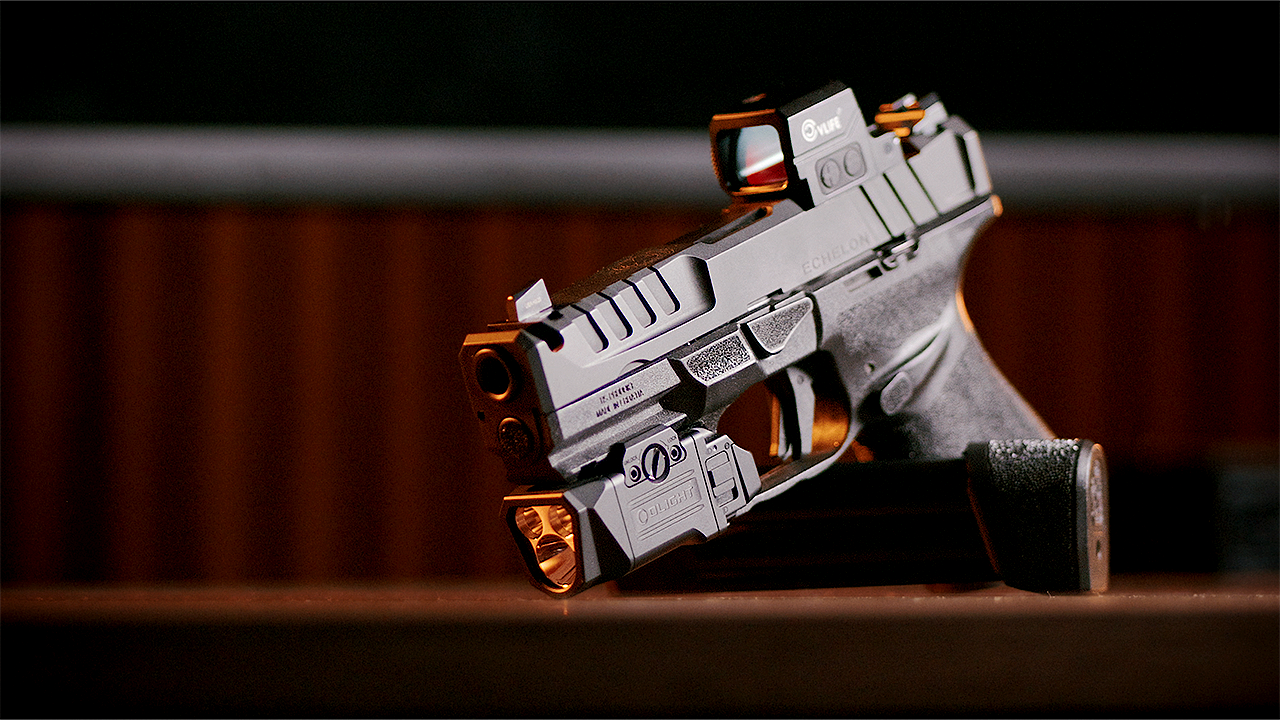 Springfield Echelon 4.0c Comp angled slightly with the Olight PL X and CVLife Wildhawk red dot