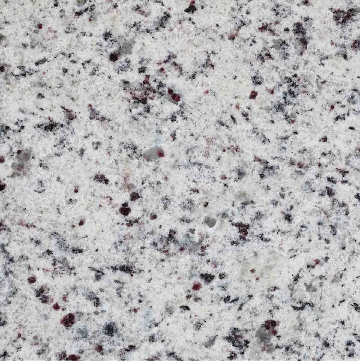 Superficie de granito con remolinos de color negro, gris y rojo en un fondo blanco.