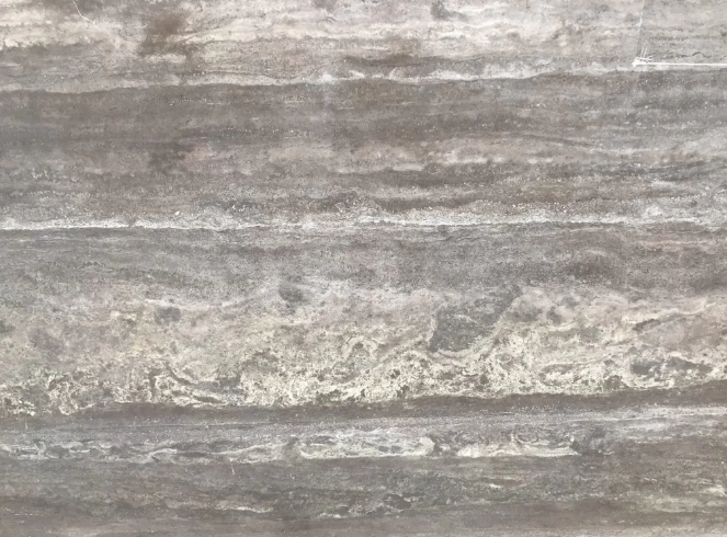 Superficie de piedra o cerámica gris con vetas y texturas en patrones naturales.