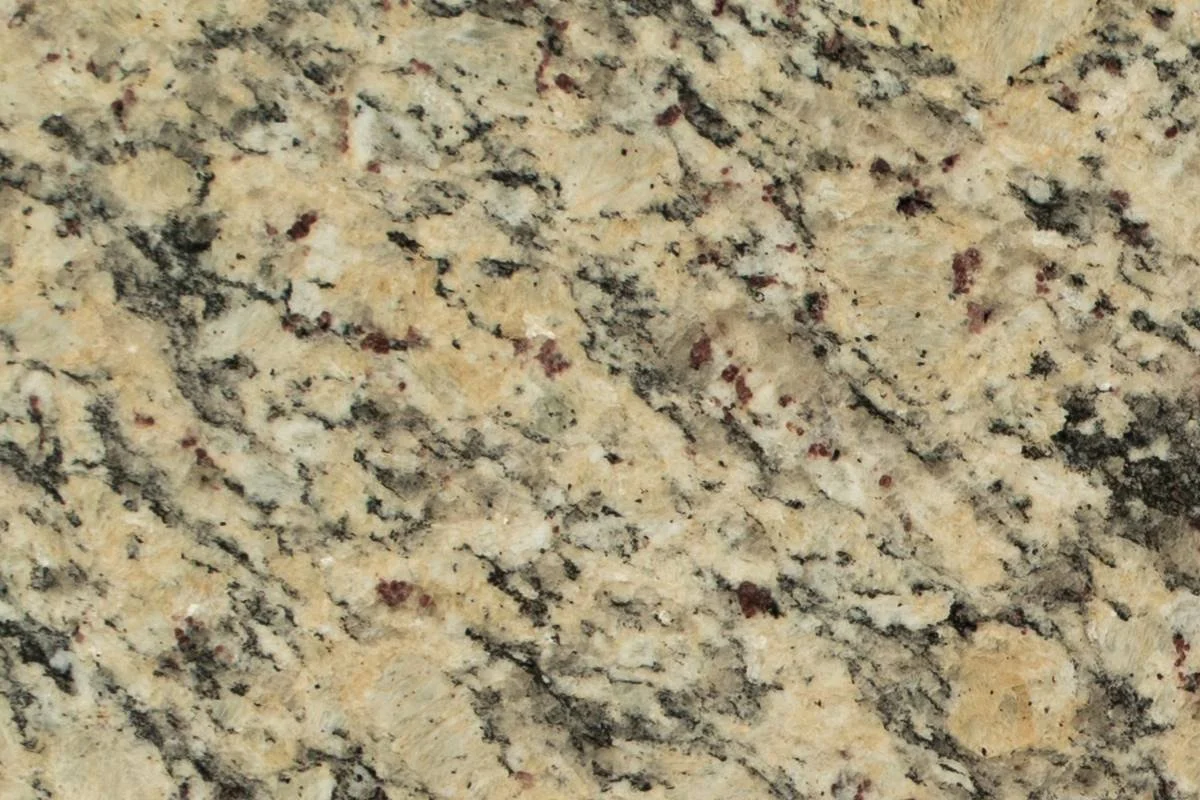 Superficie de granito con patrones en tonos beige, negro y rojo.