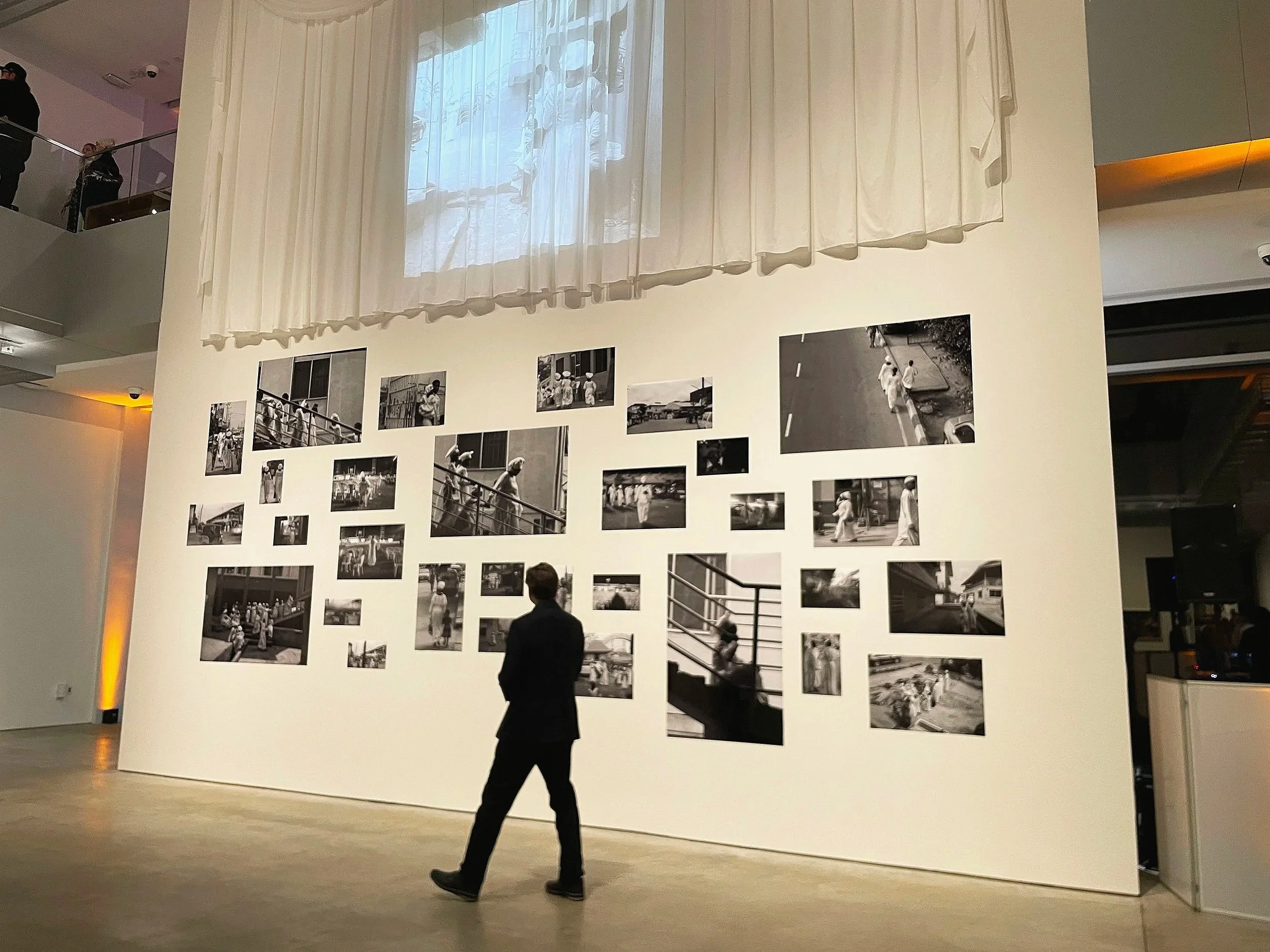 We are Here Exhibit at the International Center for Photography - Visitor in front of photo wall