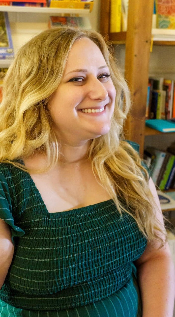 headshot in front of bookshelf