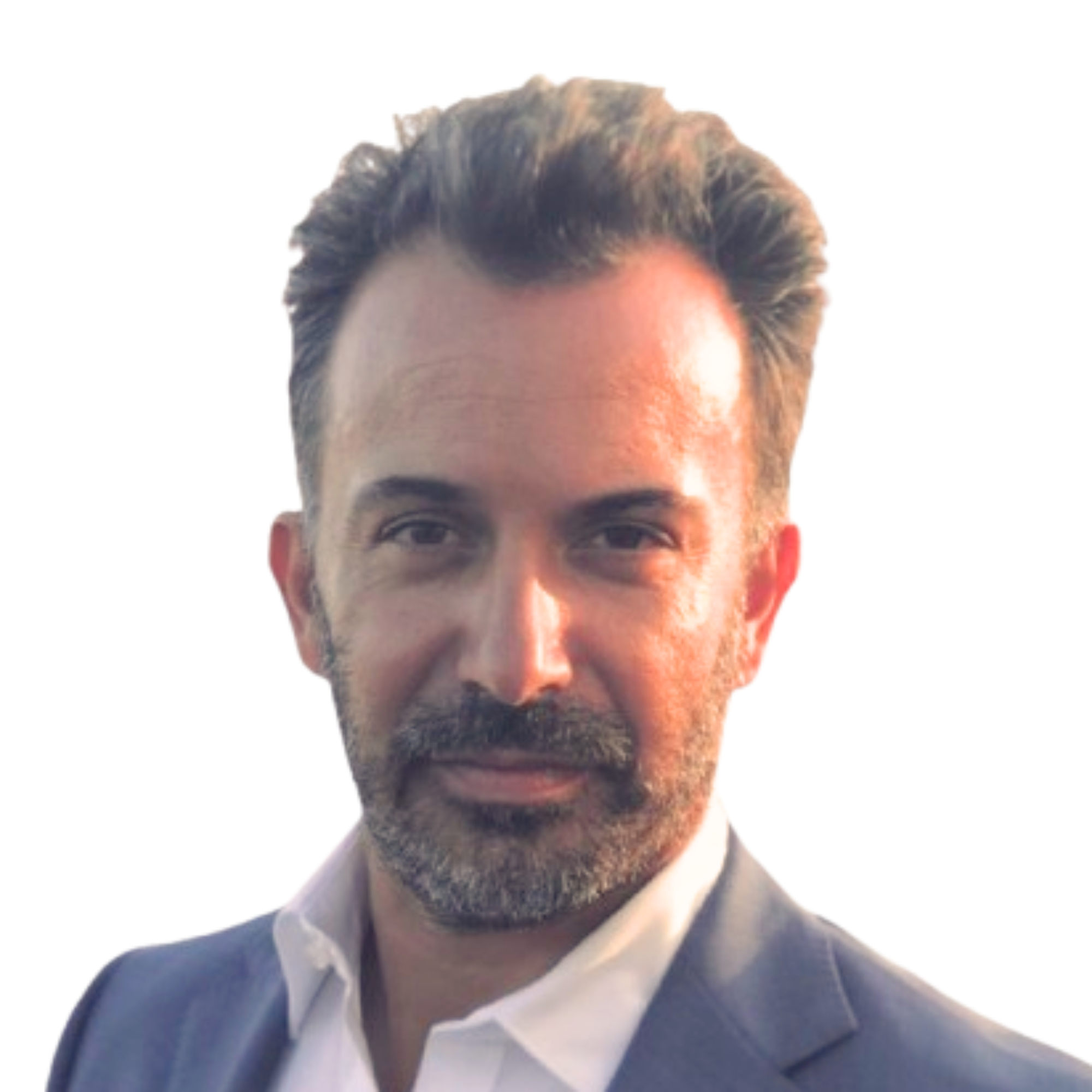 Professional man with dark hair, beard, wearing a white shirt and dark suit, looking into the camera with a confident expression.