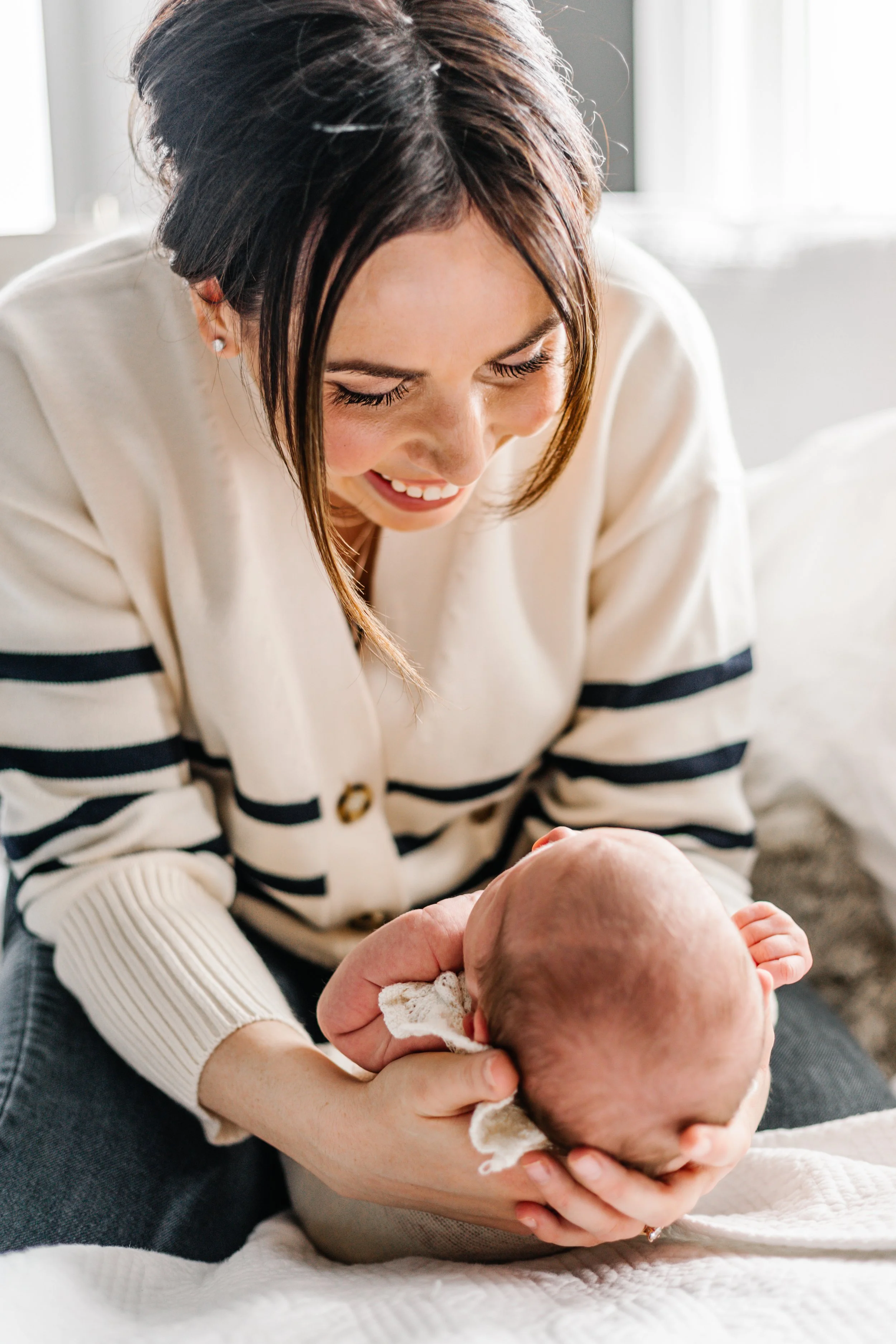 Smiling woman holding a baby