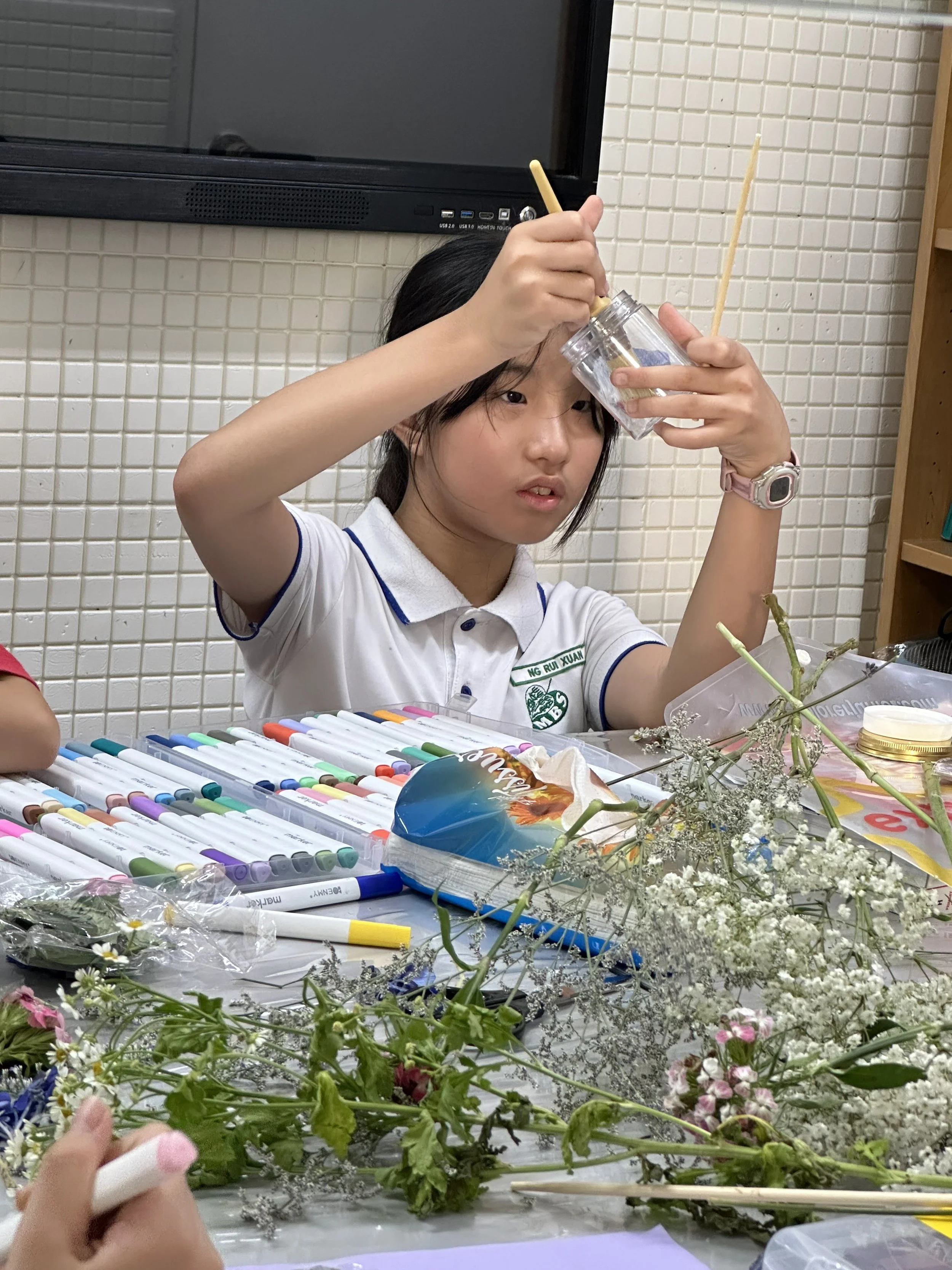 Student exploring science materials during STEM learning in Explorer Junior afterschool programme
