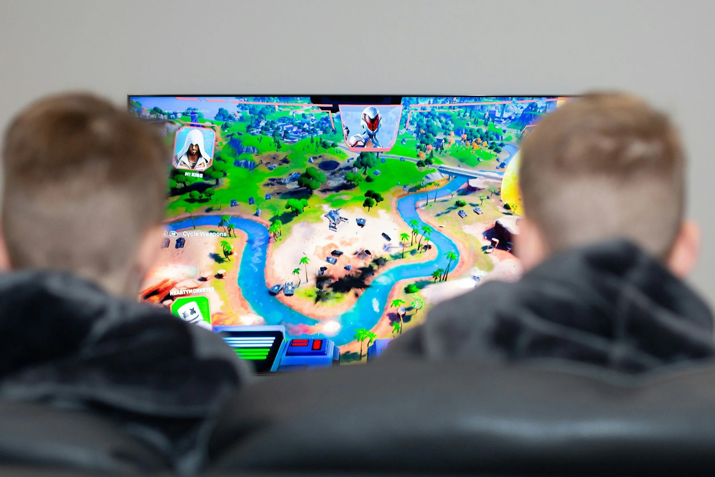 Two children watching a multiplayer online game together at home